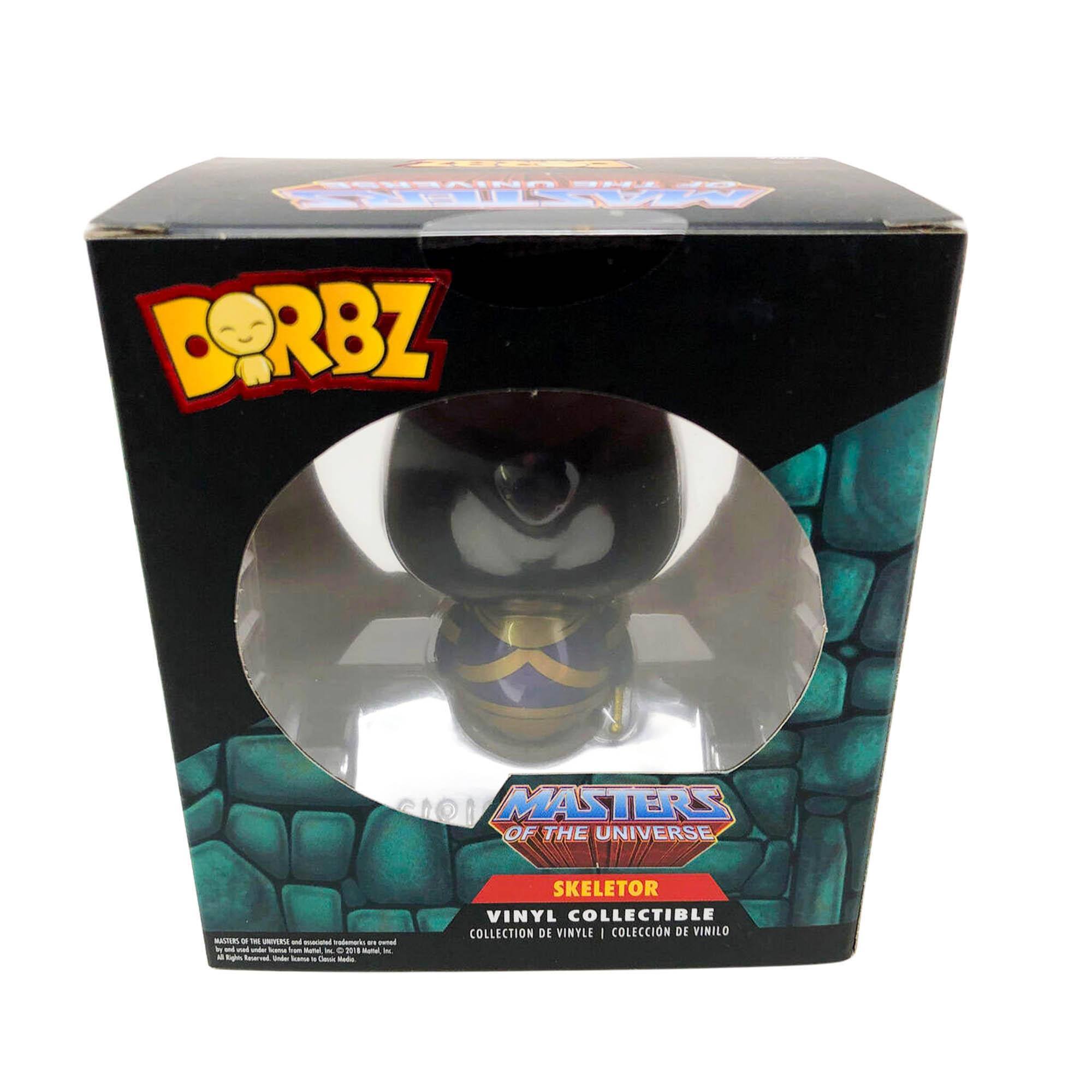 Sure, here is the corrected and grouped text from the image:

---

**Top Left:**
- DORBZ

**Top Center:**
- Masters of the Universe

**Center:**
- Skeletor

**Bottom Center:**
- Vinyl Collectible
- Collection de Vinilo
- Collection de Vinilo

**Bottom Left:**
- Masters of the Universe
- Skeletor

**Bottom Right:**
- Made in China
- © 2019 Mattel, Inc. All Rights Reserved. Masters of the Universe and all associated characters and elements are trademarks of and © Mattel, Inc. © 2019 Mattel, Inc. All Rights Reserved. Licensed by Mattel, Inc. China 2019

---