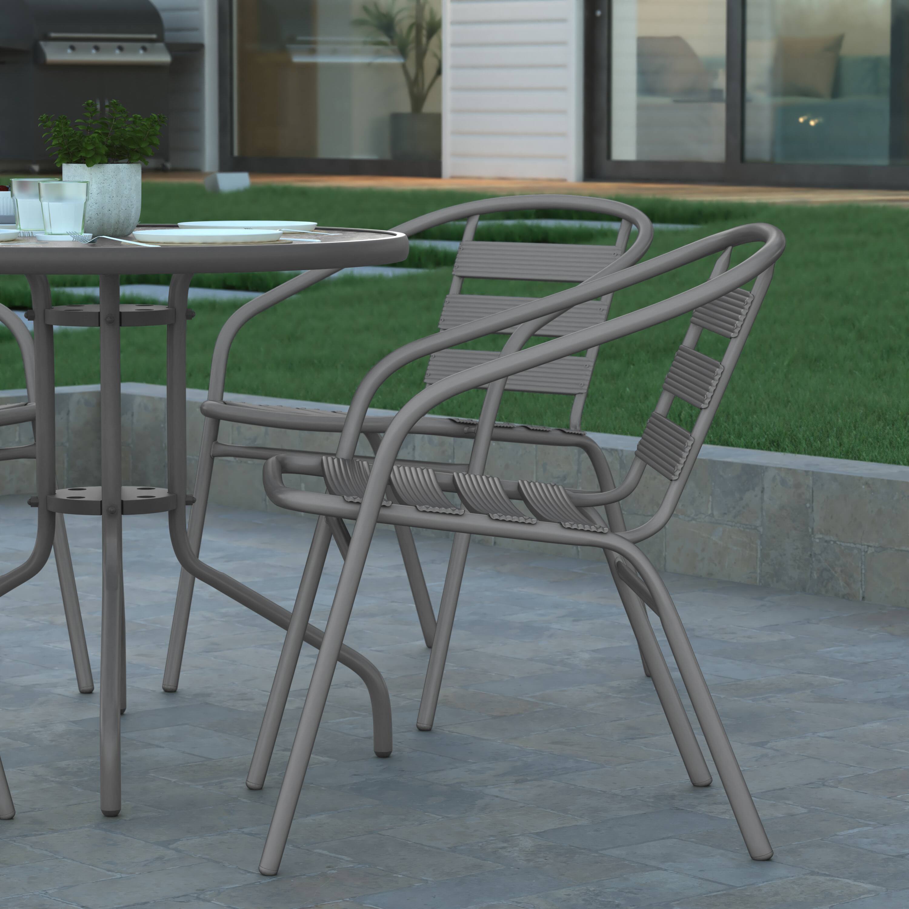 Alt View 5. Emma + Oliver - Rhea 31.5'' Round Glass Top Metal Table with 4 Aluminum Slat Stack Chairs - Silver.