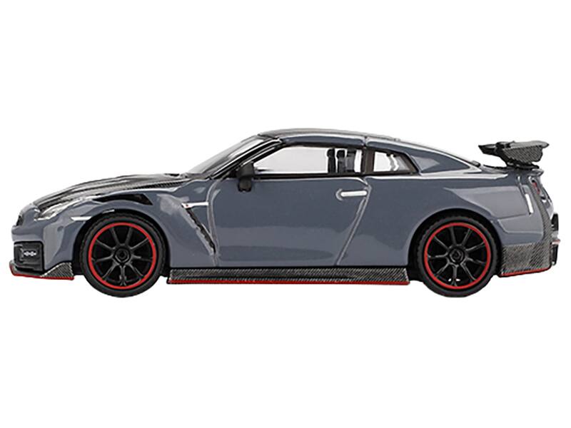Angle. Mini GT - 2024 Nissan GT-R Nismo (R35) Stealth Gray with Carbon Hood and Top Limited Edition 1/64 Diecast Model Car by Mini GT - ay with Carbon.