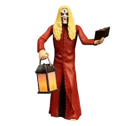 The text "ALD GIL" appears to be a misinterpretation or a typo. There is no text in the image that reads "ALD GIL." The image shows a figure with a skull face, long blonde hair, wearing a red robe, holding a lantern in one hand and a book in the other.