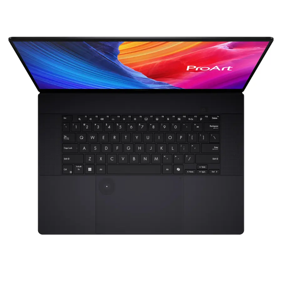 The image features a black laptop computer with a keyboard and a screen. The screen displays the ProArt logo, which is a brand of laptops. The keyboard is positioned in front of the screen, and the laptop is open, showcasing its features.