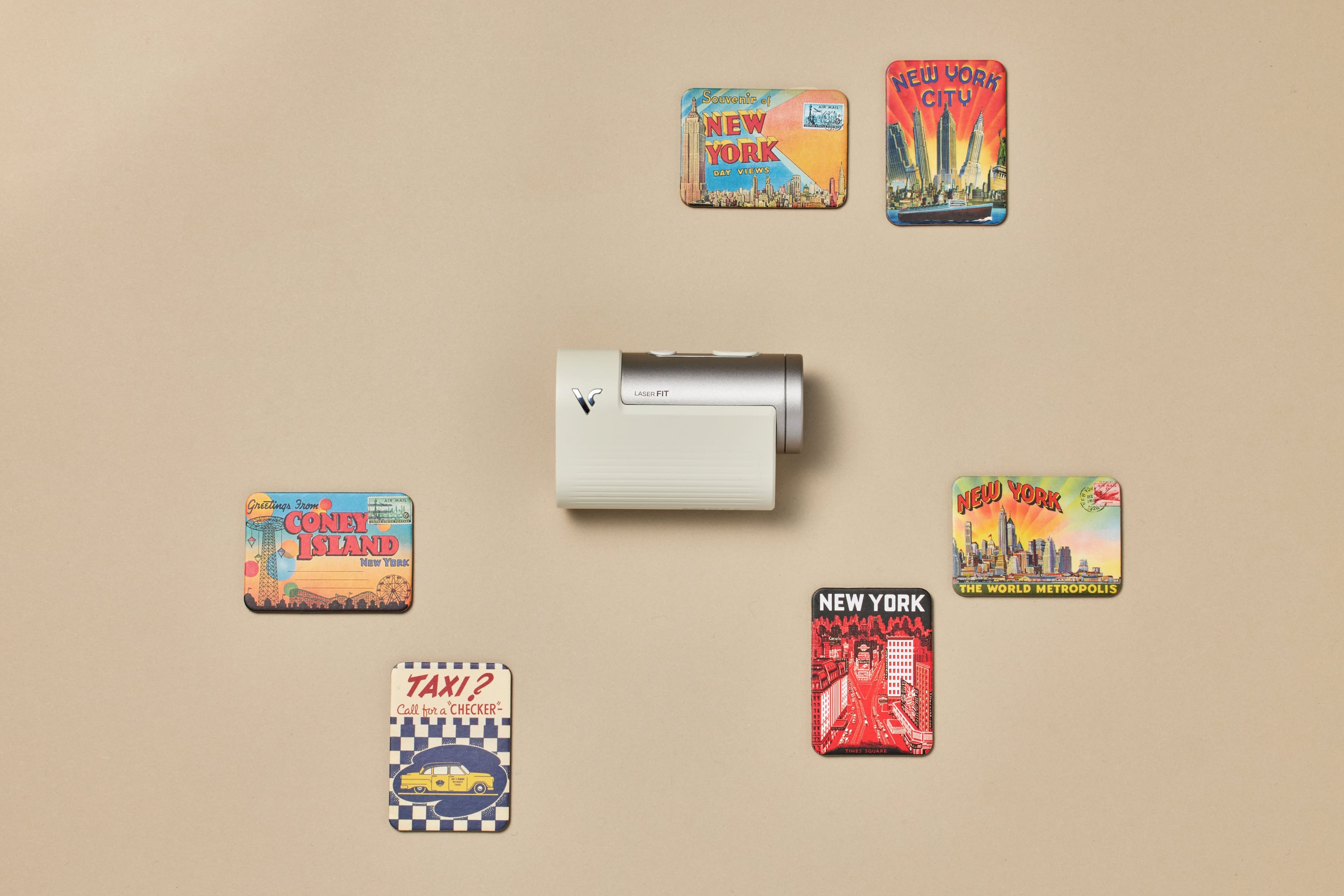 The text on the image can be grouped and corrected as follows:
1. Souvenir of New York:
"Souvenir of New York: The World Metropolis"
2. Coney Island:
"Coney Island"
3. Taxi?:
"Call for a Checker - An - A"
4. Laser HT:
"Laser HT"
5. Grattings:
"Grattings"
The corrected text is:
1. Souvenir of New York: The World Metropolis
2. Coney Island
3. Taxi?: Call for a Checker - An - A
4. Laser HT
5. Grattings