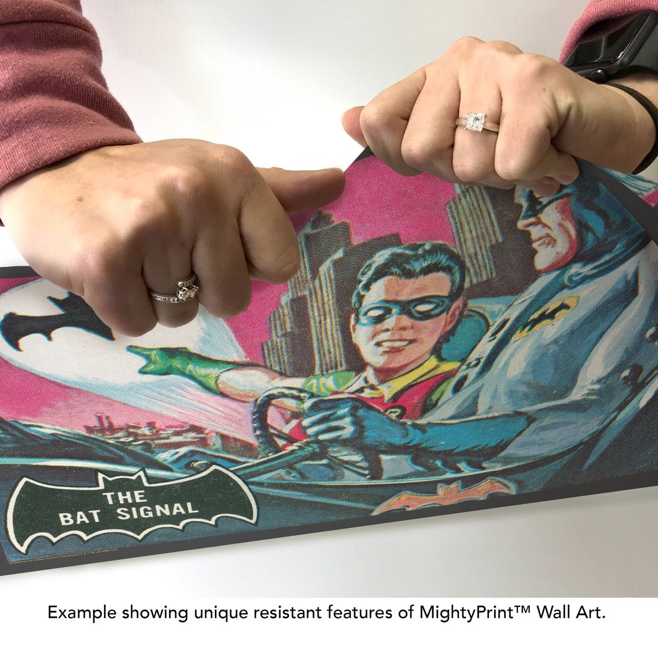 The text on the image can be grouped and corrected as follows:

---

**THE BAT SIGNAL**

Example showing unique resistant features of MightyPrint™ Wall Art.

---

This text highlights the durability and quality of the MightyPrint™ Wall Art, using "The Bat Signal" as an example.