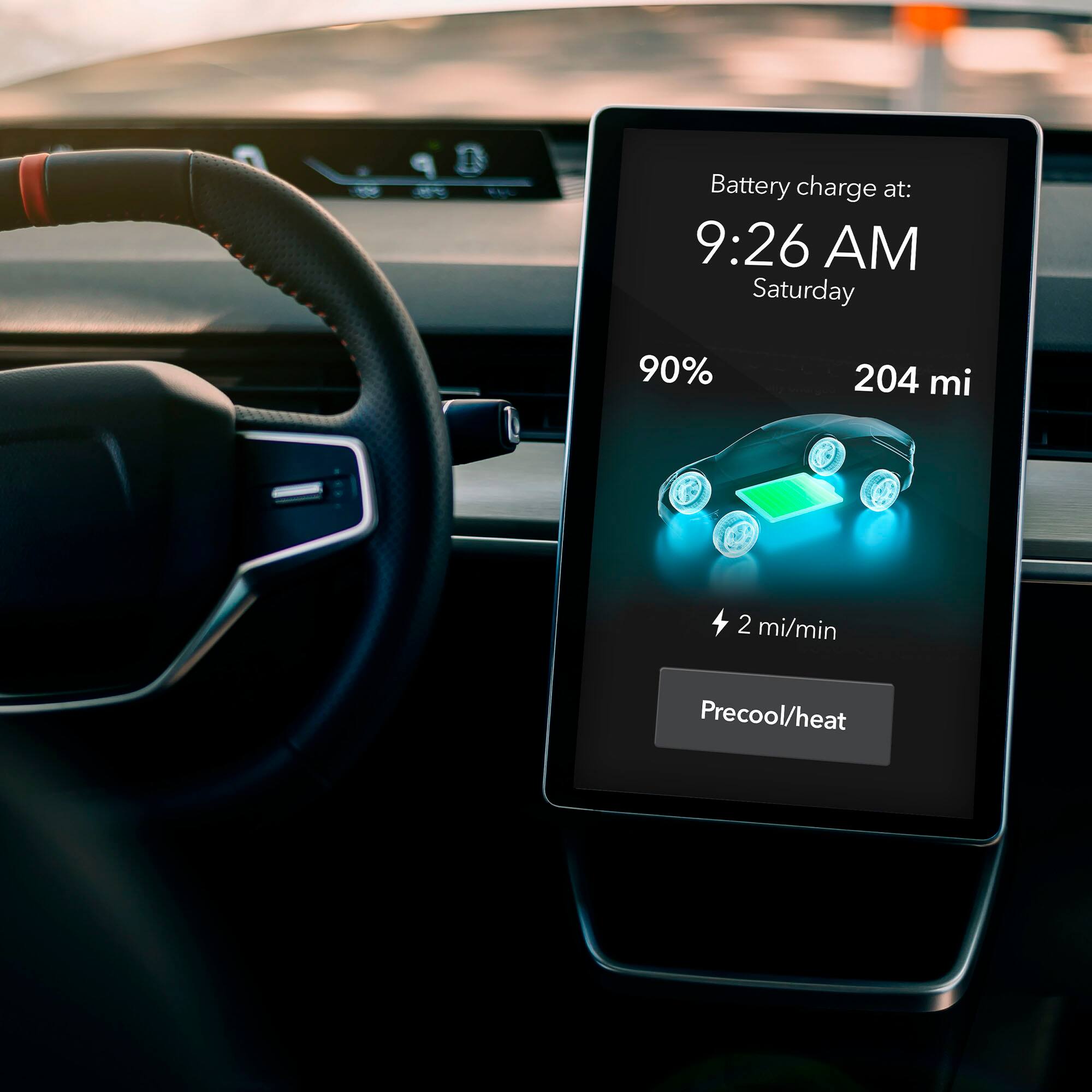 The image shows a car's dashboard with a display showing the battery charge at 9:26 AM on Saturday. The battery is at 90%, with a range of 204 miles. The display also indicates that the car is currently precooling or heating, depending on the temperature outside.