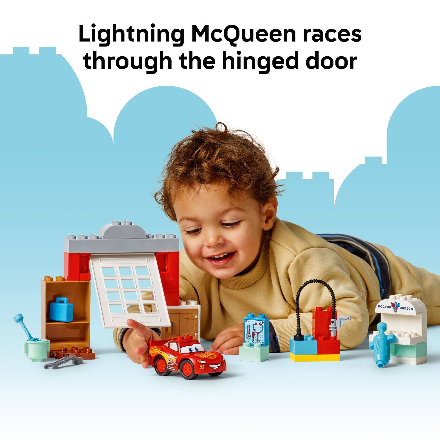 Lightning McQueen races through the hinged door.