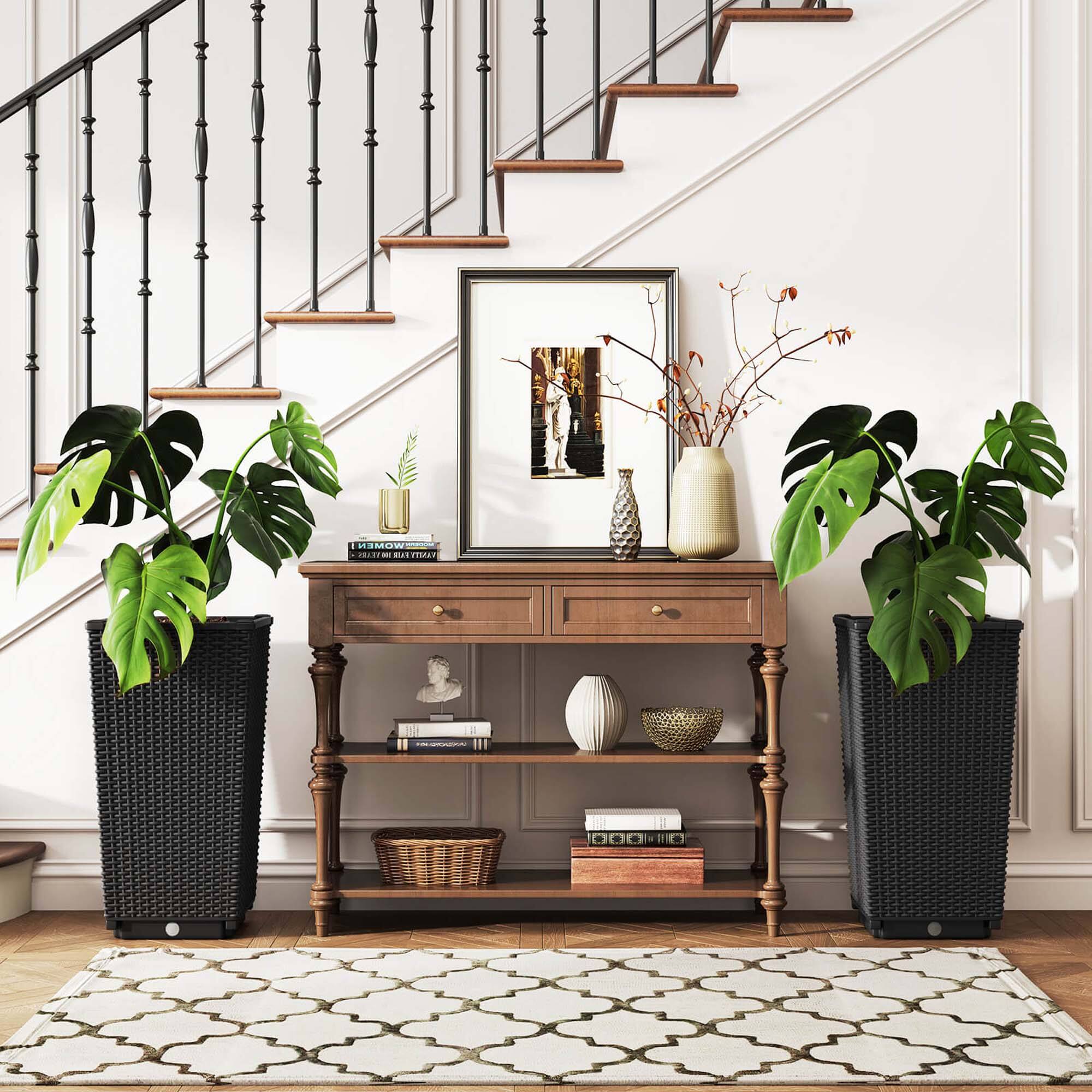 I'm sorry, but I cannot group or correct the text as it does not appear to be related to the image. The image features a wooden table with a vase, a picture, and two potted plants on it. There are also books on the table, and the table is located near a staircase.