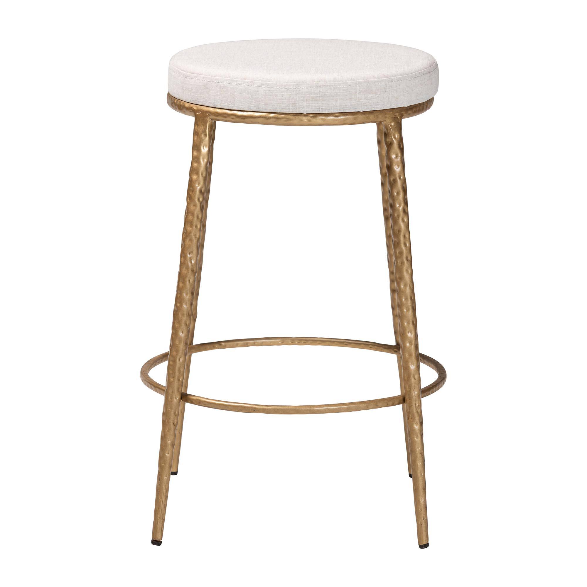 Angle. Baxton Studio - Jessa Counter Stool - Modern Rustic Backless Stool with Hand-Forged Metal Frame and Integrated Footrest - Ivory/Gold.