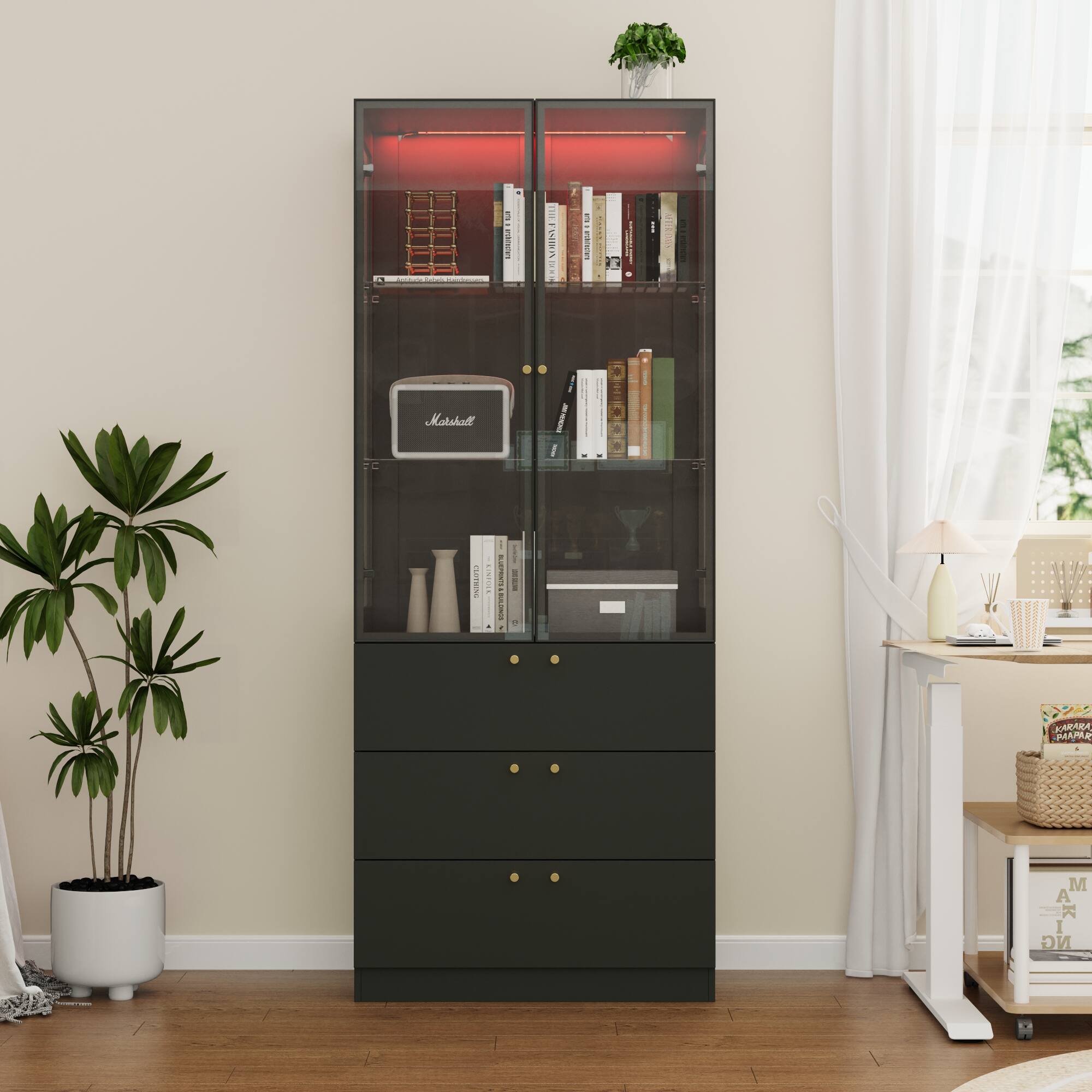 Sure, here is the corrected and grouped text from the image:

**Top Shelf:**
- Books (titles not clearly visible)

**Second Shelf:**
- Books (titles not clearly visible)

**Third Shelf:**
- Marshall (logo on a device)

**Fourth Shelf:**
- Books (titles not clearly visible)

**Fifth Shelf:**
- Books (titles not clearly visible)

**Bottom Shelf:**
- Books (titles not clearly visible)

**Drawer Labels:**
- (No visible labels on the drawers)

**Additional Text:**
- "M A R T I N" (on a book on the desk)

**Other Visible Text:**
- "KARIBA" (on a box on the desk)
- "KARIBA" (on a box on the desk)