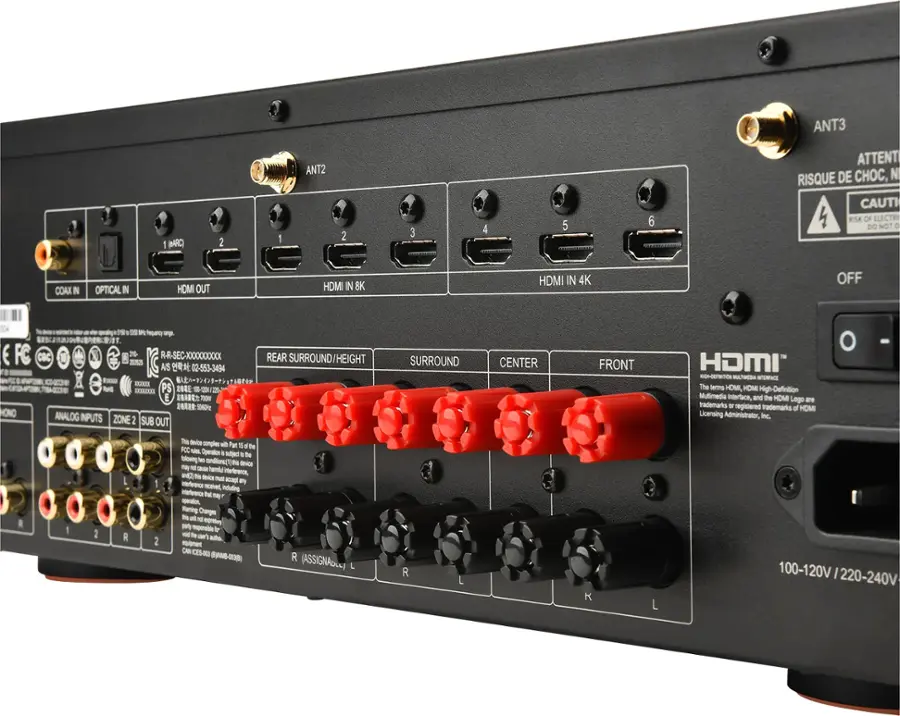 The image features a black electronic device with a row of red buttons labeled "1" through "6" on the front. The device is an HDMI switcher, which allows users to switch between multiple HDMI inputs. The switcher is designed to handle 4K and 8K resolutions, providing high-definition multimedia interface capabilities. The device also has a warning label on the back, cautioning users about the risk of electric shock. The HDMI switcher is made by HOMI, a company known for its registered trademarks in the electronic industry.
