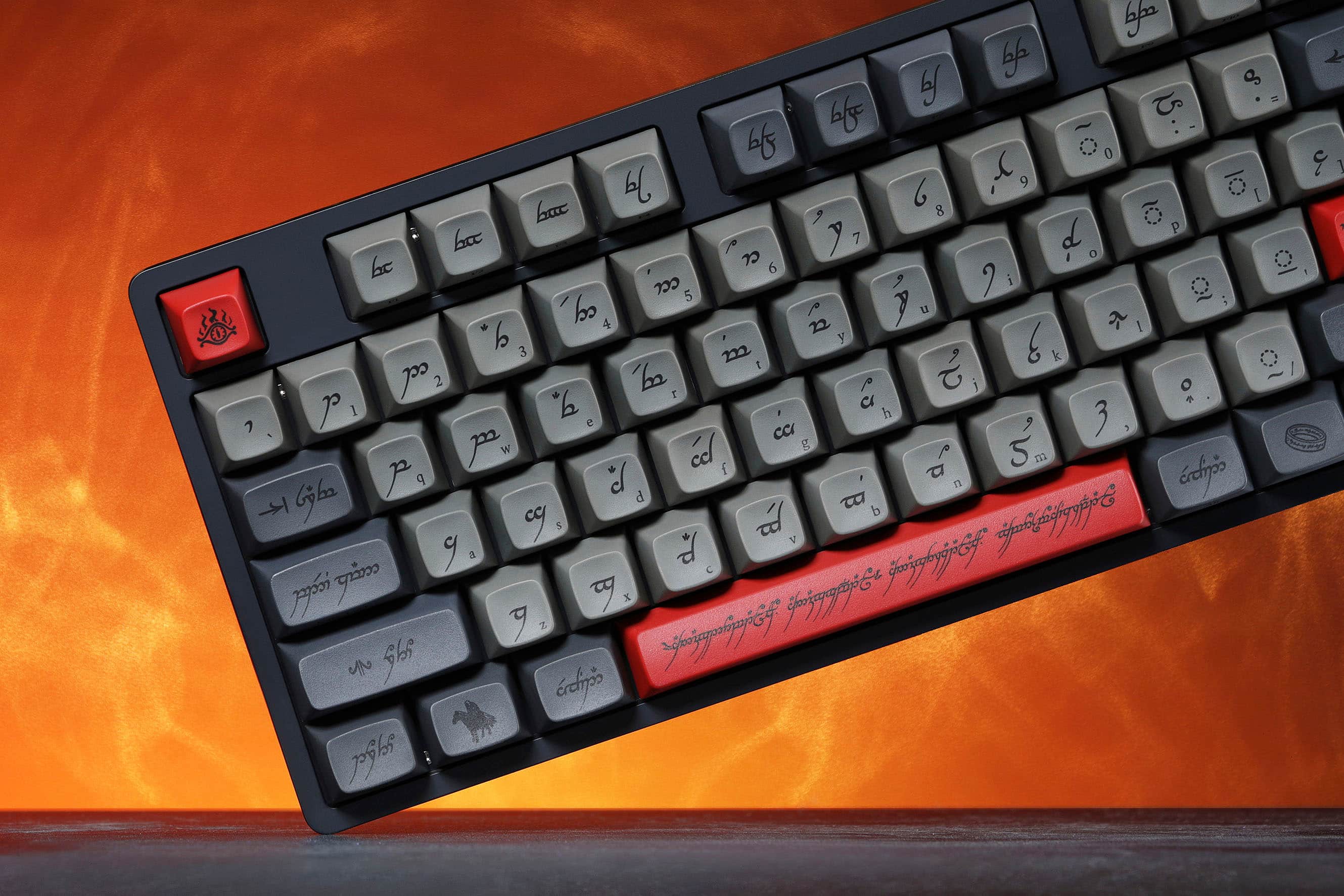 The text on the image is in a foreign language, so it is not possible to group and correct it without understanding the language. However, I can provide some general information about the keyboard layout.
The keyboard in the image has a unique layout with several non-standard keys. It has a red key on the left side, which is likely the Shift key. The rest of the keys are arranged in a way that is not typical of standard keyboards. The keys are likely designed for a specific language or purpose, as the layout deviates from the standard QWERTY or AZERTY layouts.
