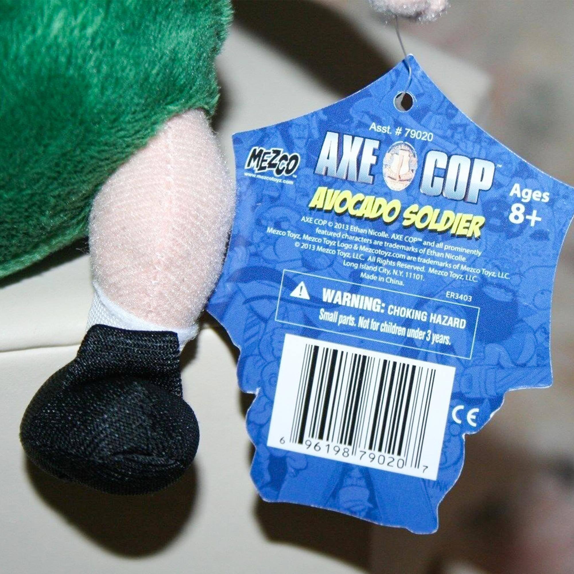 Asst. # 79020 MEZCO AXE COP AVOCADO SOLDIER Ages 8+  
AXE COP 2013 Ethan Nicolle.  
Mezco Toyz, featured characters are AXE COP and 2013 Logo & trademarks all Mezco Toyz, Mezcotoyz.com of Ethan Nicolle prominently LLC All Rights Reserved.  
Made in China, N.Y. 11101.  
Mezco Toyz, LLC.  
WARNING: CHOKING HAZARD Small parts. Not for children under 3 years.  
ER3403  
6 96198 79020 7 CE
