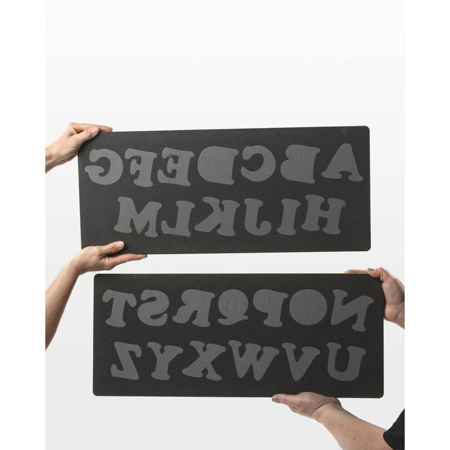 The text on the image is "HIKMLEC" and "NUVWXYZ". So, the corrected text is "ABCDEFG HIJKLM NOPORST UVWXYZ".