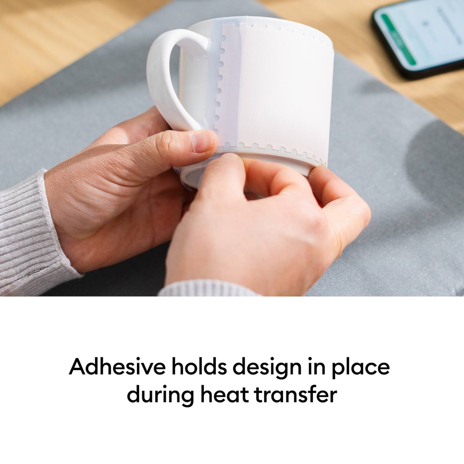 Adhesive holds design in place during heat transfer
