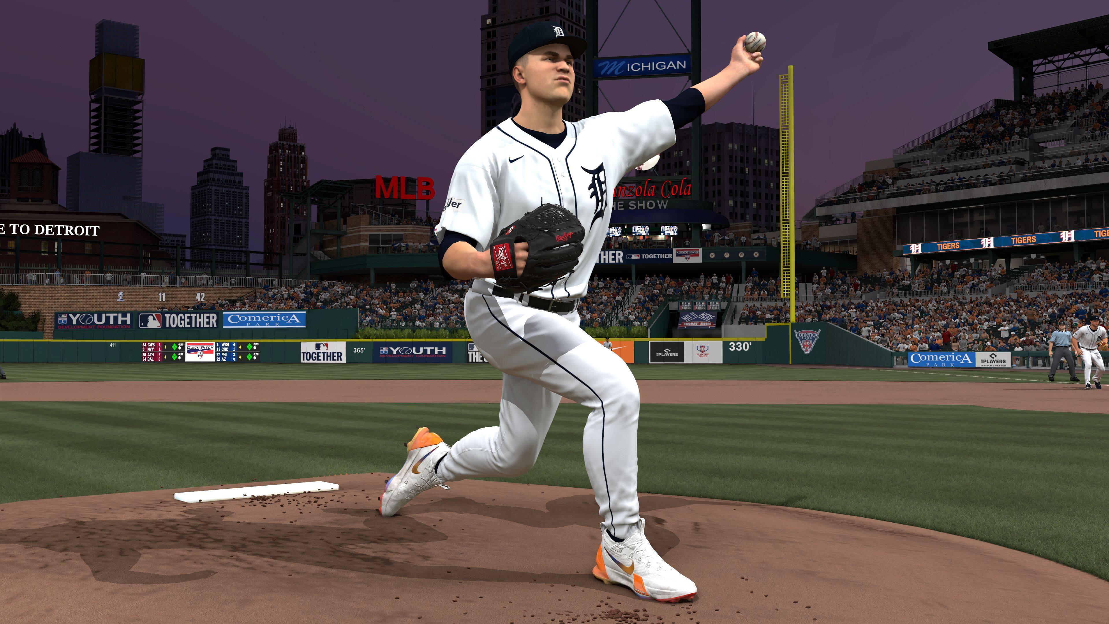The image shows a baseball player in a white uniform, standing on a baseball field and preparing to throw a pitch. The player is wearing a cap and a baseball glove. The scene is set at night, with a city skyline visible in the background. The player is likely a pitcher for the Detroit Tigers, as he is wearing a jersey with the team's logo. The image also features an advertisement for Comerica Bank, which is a sponsor of the Detroit Tigers.