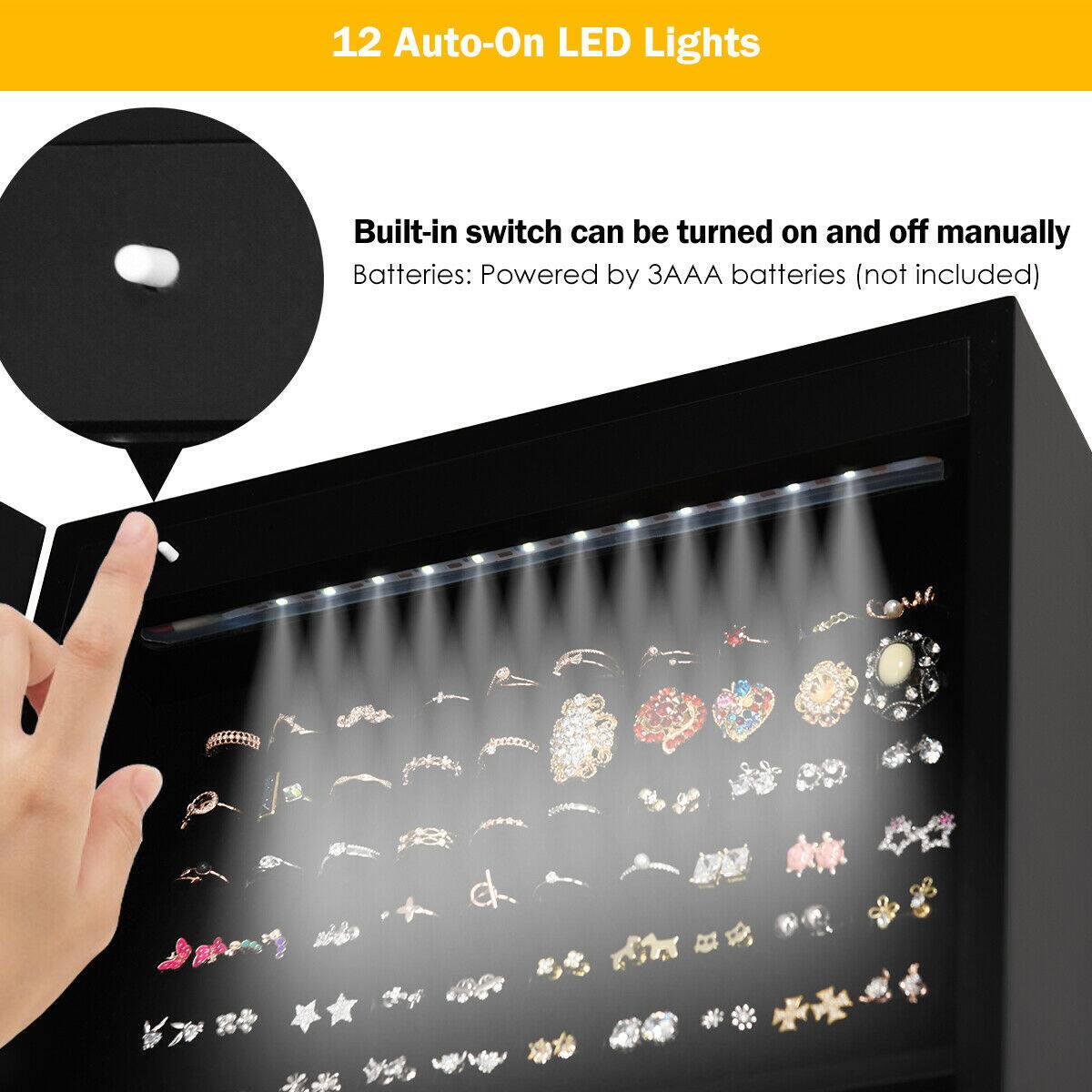The image features a display case with a variety of rings and other jewelry items. The display case is illuminated by 12 auto-on LED lights, which can be turned on and off manually. The display case is powered by batteries, which are not included in the package. The display case is designed to showcase the rings and other jewelry items in an attractive and well-lit manner.
