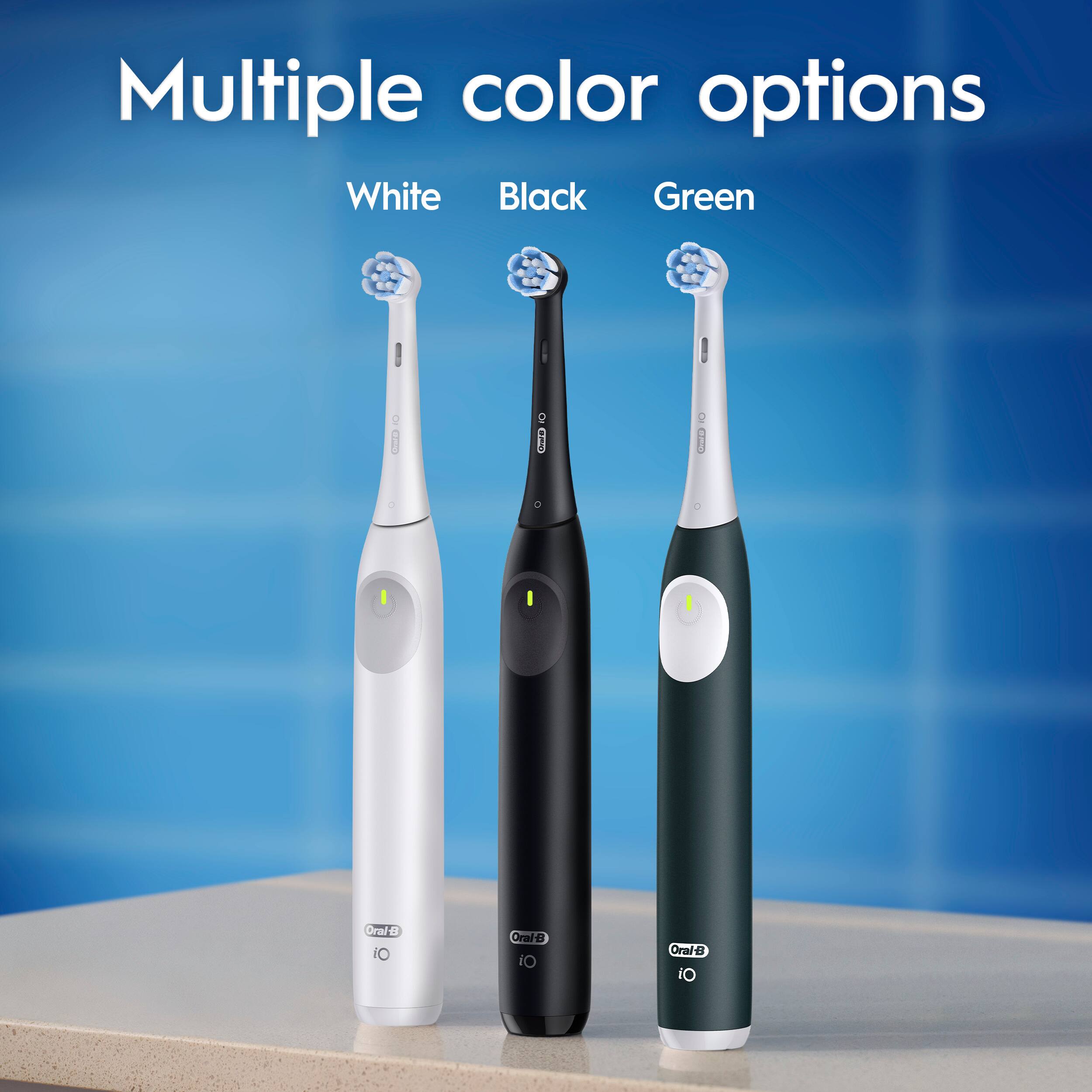 Multiple color options are available for toothbrushes, including White, Black, Green, and Oraie. The toothbrushes are displayed in a row, with one toothbrush being white, another black, and the third one green. The toothbrushes are made by Oral-B and Oraie.