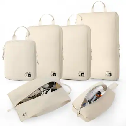 The image features a collection of white bags, including a backpack, a handbag, and a suitcase. The backpack is placed on the left side of the image, while the handbag is positioned in the middle. The suitcase is located on the right side of the image. The bags are all white and have a similar design, giving them a cohesive appearance.