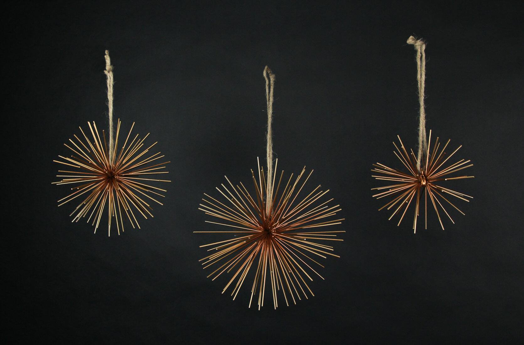 Alt View 1. Zeckos - Brass Finish Metal Bursting Star Decorative Hanging Ornaments Set of 3 Rope Hangers - Gold.