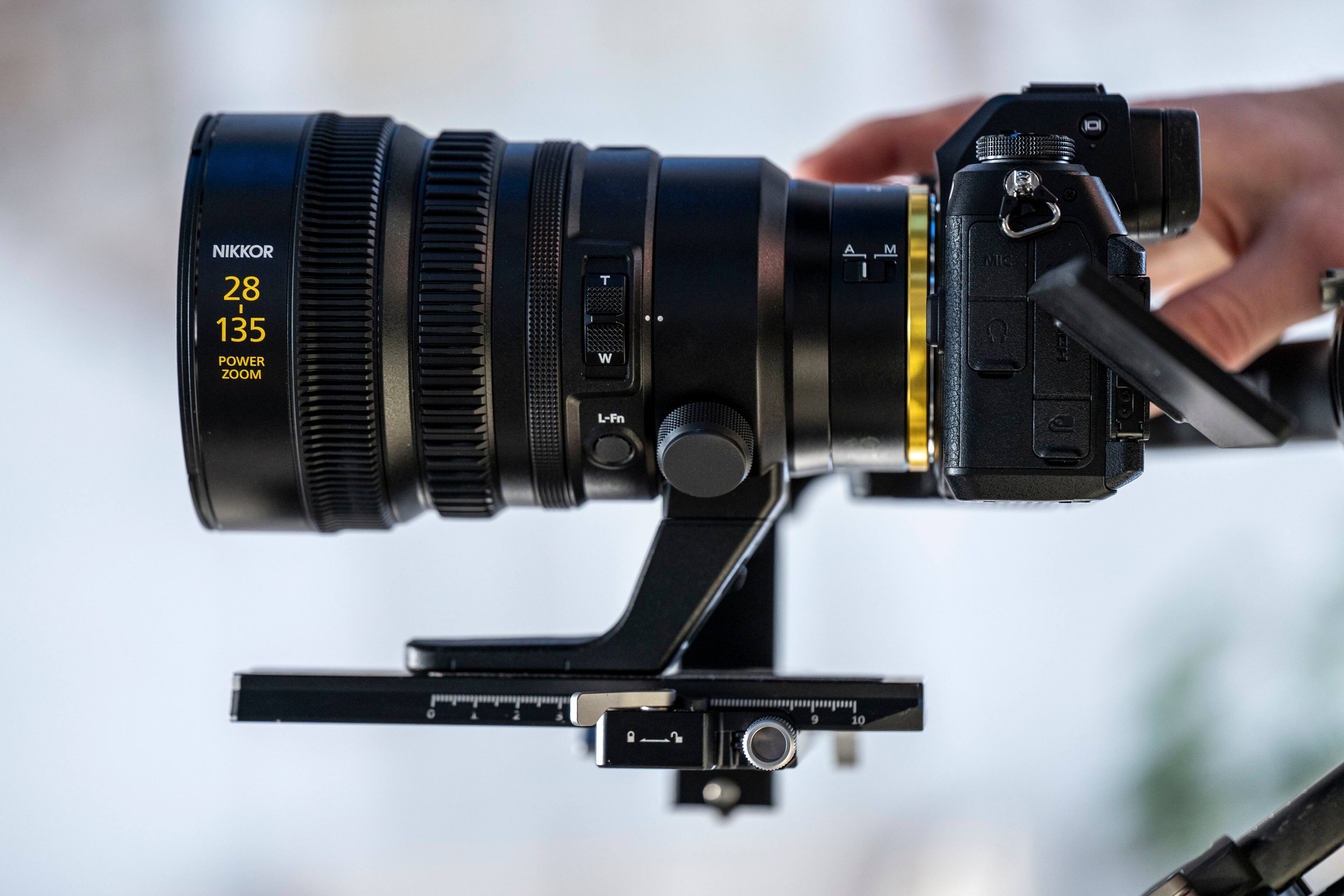 The text on the image reads "NIKKOR 28 I 135 POWER ZOOM T W A, A I M MIS L-Fn."