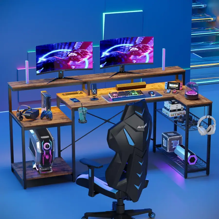 The image features a desk with a black chair, two computer monitors, and a keyboard. There are also two computer mice on the desk, and a cell phone is placed nearby. The desk is set up for a gaming experience, with the monitors and keyboard ready for use. The black chair is positioned in front of the desk, providing a comfortable seating area for the user.