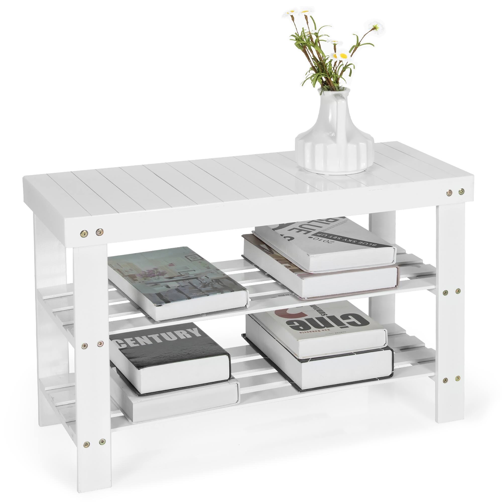 A white table with a vase of flowers and a stack of books on it.