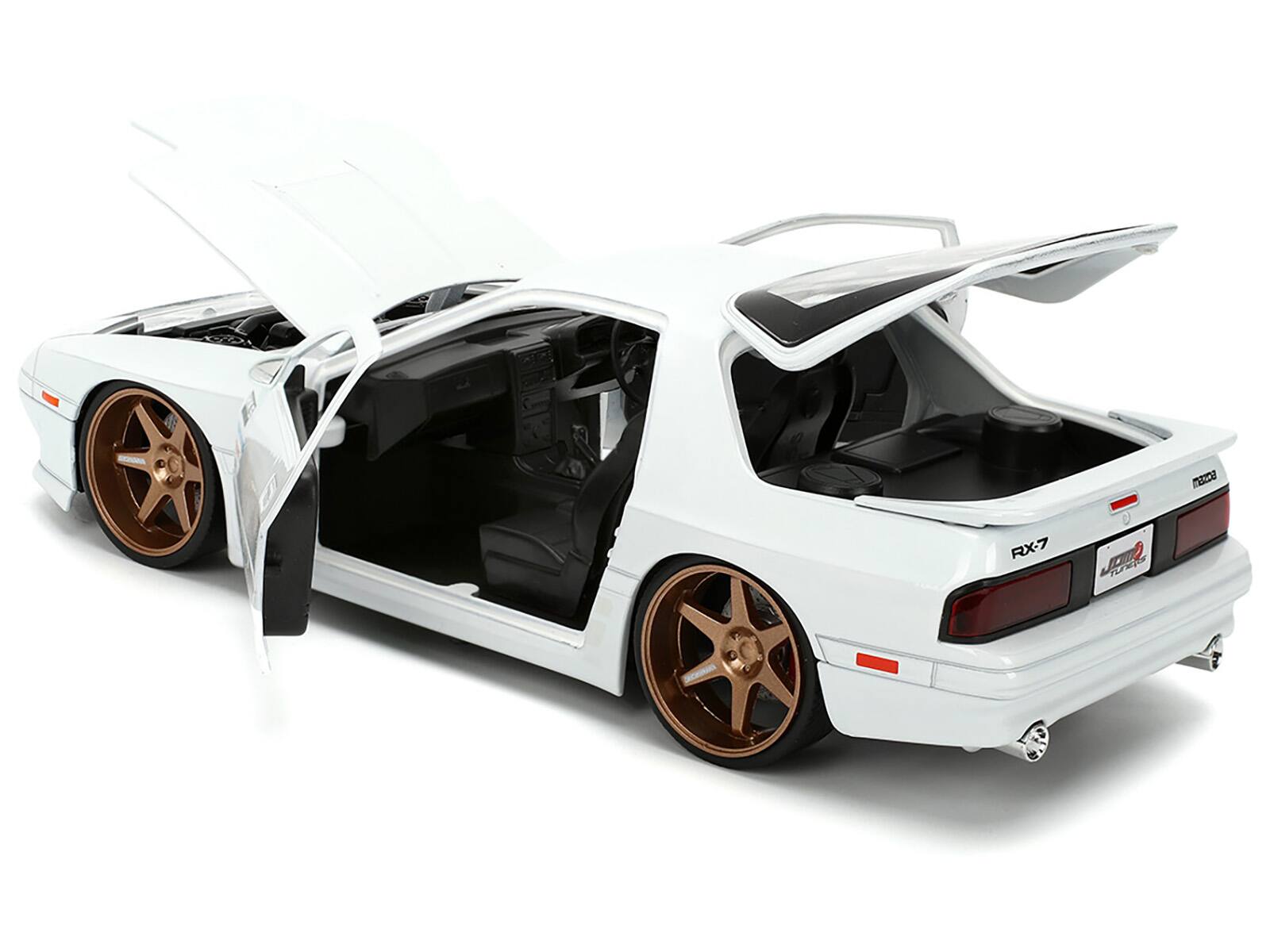 Back. Jada - 1985 Mazda RX-7 White "JDM Tuners" Series 1/24 Diecast Model Car by Jada - White.