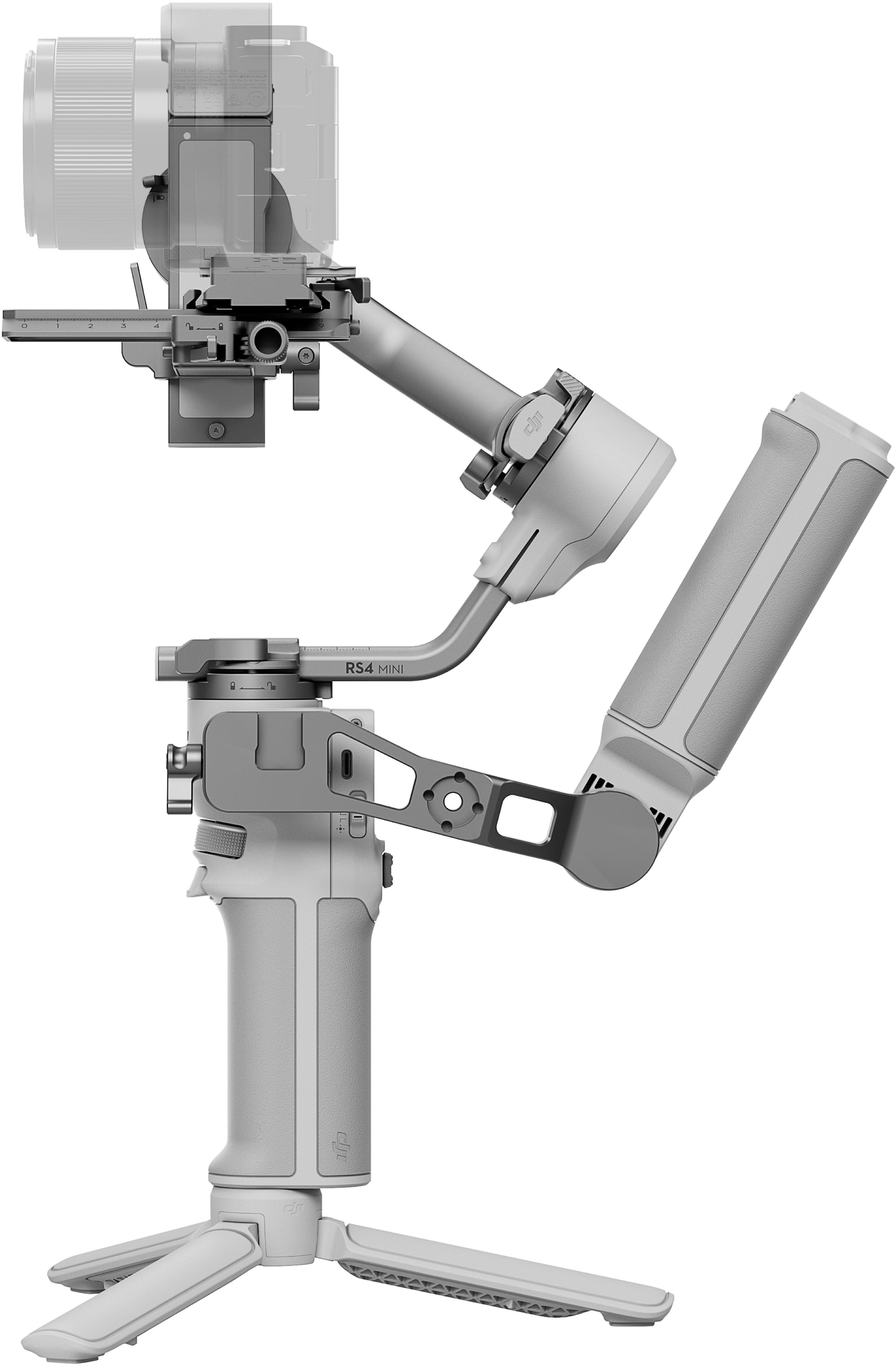 The image shows a robotic arm, specifically a RS4 MINI, which is a small robotic arm. The arm is white and has a metal frame. It is designed to perform various tasks, such as picking up and moving objects. The arm is mounted on a stand, which provides stability and support for the device. The RS4 MINI is a versatile and compact robotic arm that can be used in a variety of applications, including manufacturing, assembly, and research.
