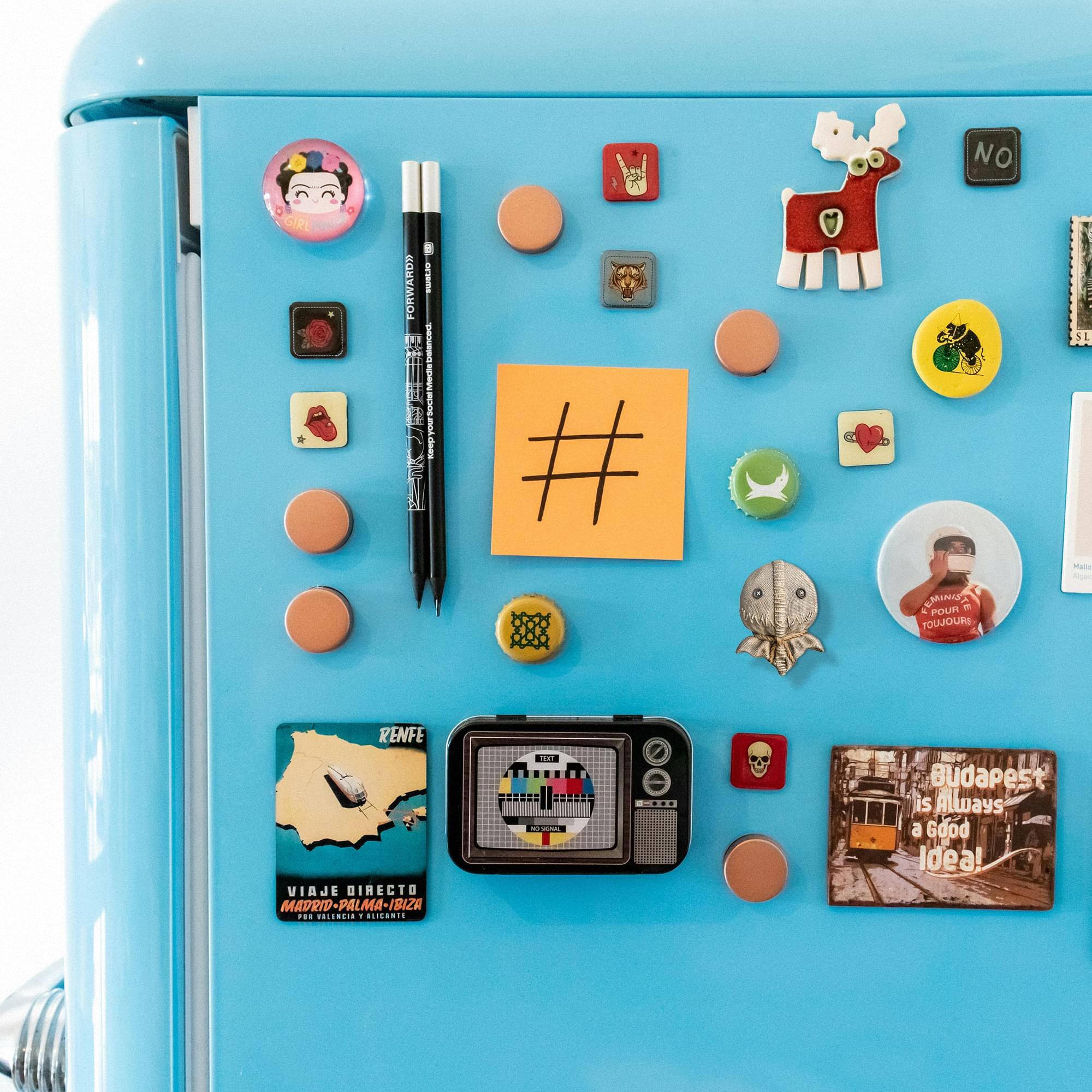 Sure, here is the corrected and grouped text from the image:

---

**Top Left:**
- NO GIRL FORWARD

**Top Center:**
- # MINIST

**Top Right:**
- POUR POUJDURS
- RENFE VIAJE DIRECTO MADRID-PALMA-IBIZA MADRID
- L.ILICONTE
- OOLENGIA
- BLIGARIS

**Bottom Left:**
- RENFE
- VIAJE DIRECTO MADRID-PALMA-IBIZA
- MADRID - PALMA - IBIZA
- 10:00 - 12:00
- 10:00 - 12:00

**Bottom Center:**
- Budapest is Always a Good Idea!

**Miscellaneous:**
- Budapest is Always a Good Idea!
- NO
- Keep it simple, stupid
- Keep it simple, stupid
- TOUJOUR
- TOUJOUR
- Mal
- Mal
- (Various small stickers and magnets with no discernible text)

---