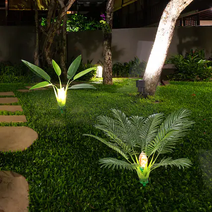 Front. Oumilen - 2 Pack Solar Garden Lights, Outdoor Waterproof Solar Pathway Lights with Artificial Palm & Leaf Design.