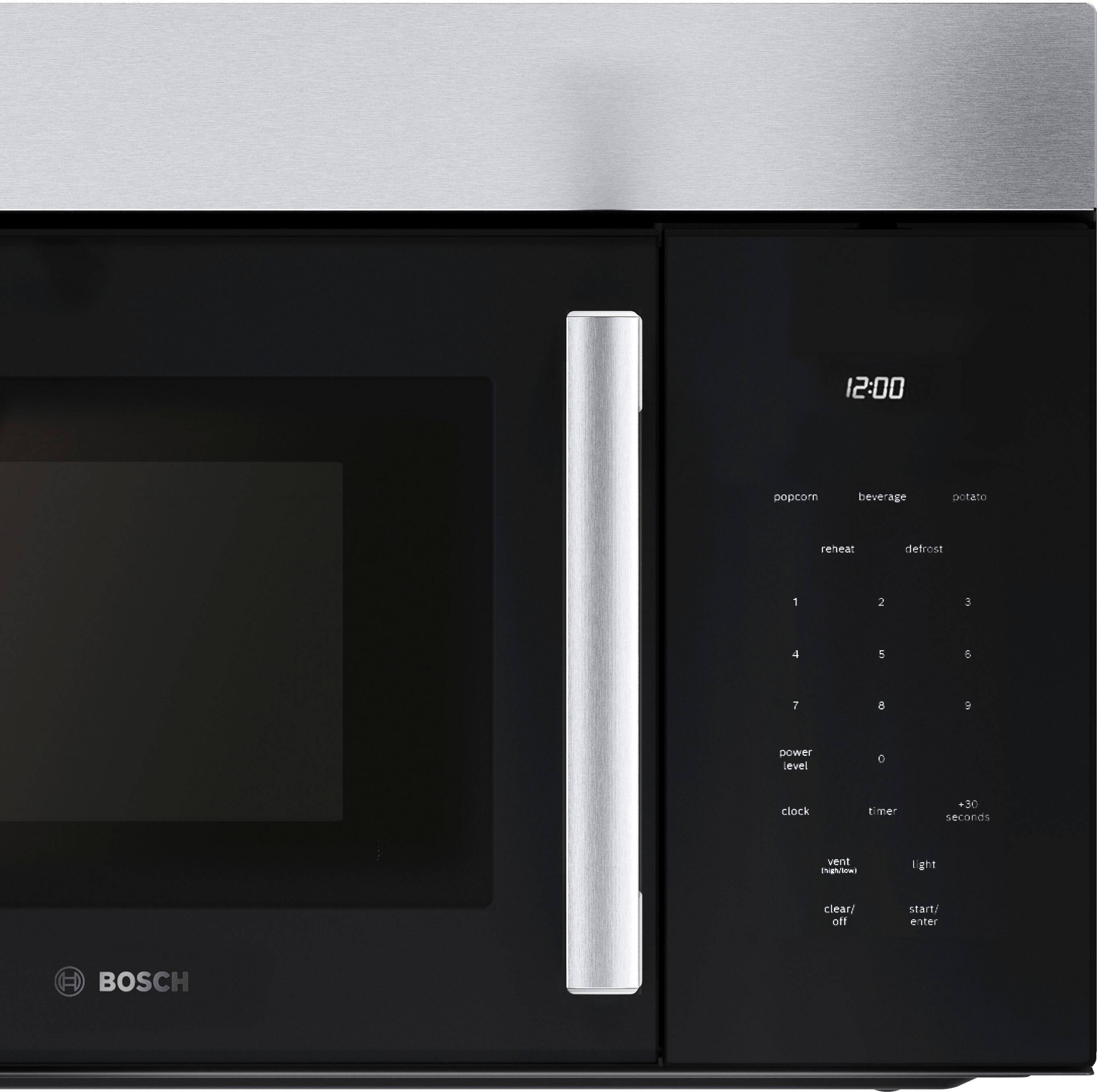 The image shows a black microwave oven with a digital clock on the front. The clock reads 12:00, indicating that it is noon. The microwave has a timer function, which allows users to set a specific time for cooking or reheating food. The buttons on the microwave include options for potato, beverage, popcorn, and defrost, among others. The microwave also has a defrost function, which can be used to thaw frozen food. The microwave is made by Bosch, a well-known appliance brand.