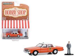 Greenlight - 1981 Chevrolet Impala Capitol Cab Taxi Orange/White Top with Man in Suit Figure The Hobby Shop Series 15 1/64 - Orange With White