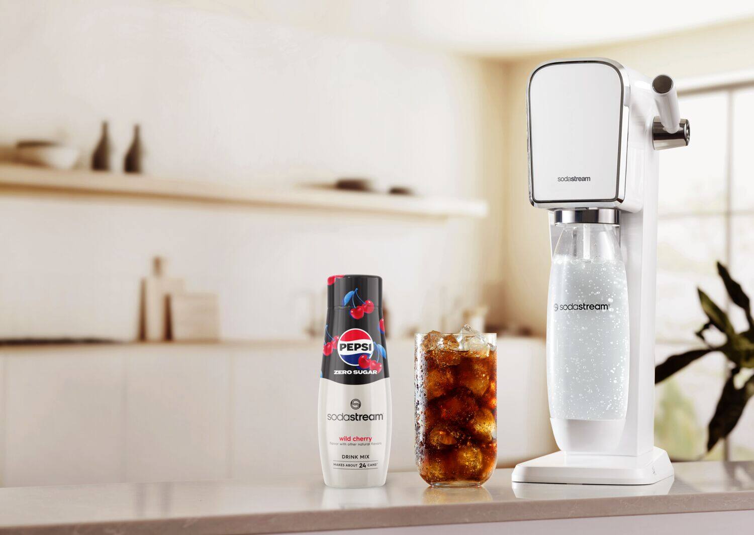 The image features a counter with a SodaStream machine and two bottles of soda. One of the bottles is a Pepsi Zero Sugar, while the other is a Wild Cherry flavored soda. The SodaStream machine is placed next to the bottles, ready to be used to make more soda.