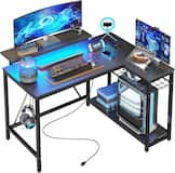 Bestier - L-Shaped Gaming Desk with Power Outlets LED Lights and Reversible Storage Shelves & Hooks - 42" Wide - Black Carbon Fiber
