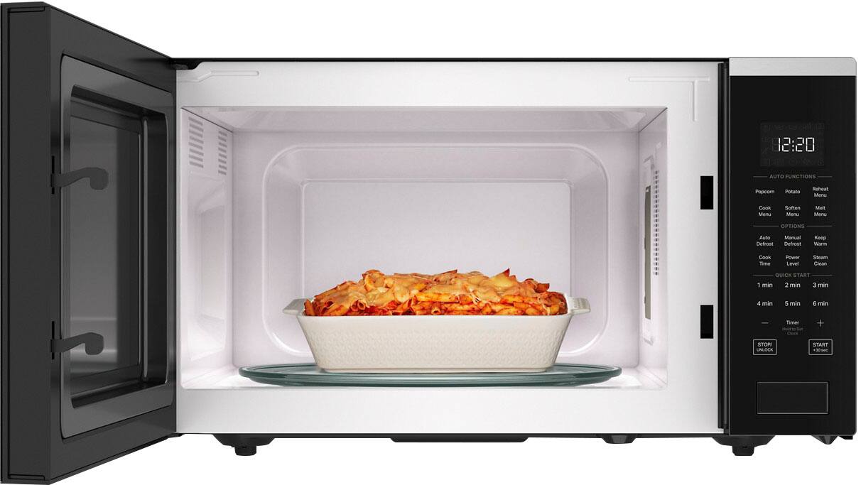 The image shows a microwave with a bowl of food inside. The microwave is set to cook the food, and the time displayed on the screen is 12:20. The microwave has various options available, such as auto functions, manual functions, defrost, and defrost options. Additionally, there are cooking options like potato, reheat, and melt. The microwave also has a timer and a clock feature, allowing users to set the desired cooking time.