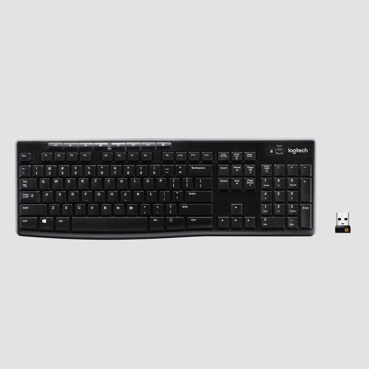 The image shows a black Logitech keyboard with a USB key next to it. The keyboard has a number pad and a backspace key. The USB key is located on the right side of the keyboard.