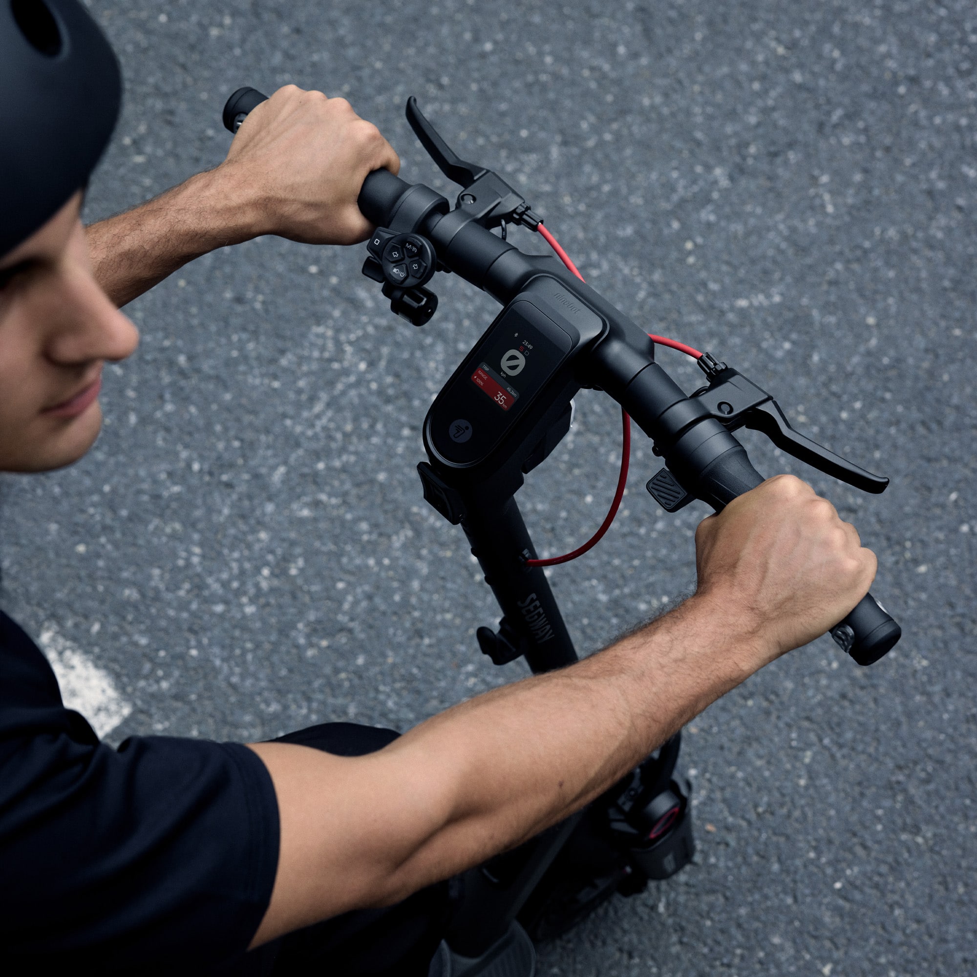 A man is sitting on the ground with a Segway.