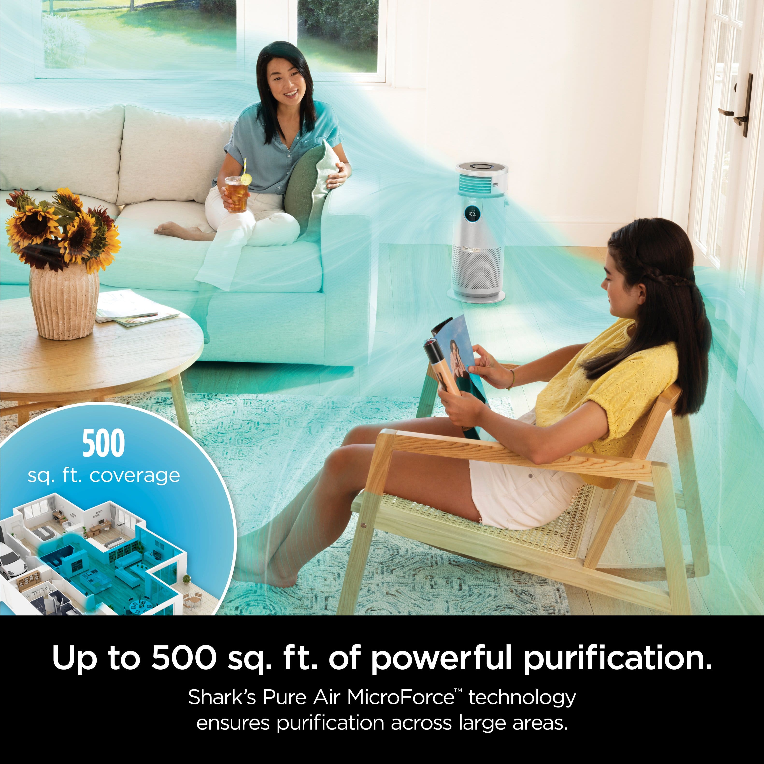 The image features two women sitting in a living room, with one of them holding a tablet. The room is furnished with a couch, a chair, and a potted plant. The women are enjoying their time together, possibly discussing or watching something on the tablet. The image also promotes a product that provides up to 500 sq. ft. of powerful purification, ensuring clean air in large areas using Shark's Pure Air MicroForce technology.