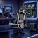 The image features a black and grey gaming chair positioned in front of a desk. The desk has a computer monitor, keyboard, and mouse on it. There are also two TVs in the room, one on the left side and another on the right side. The room is designed for gaming and entertainment, with the chair and desk setup providing a comfortable space for playing video games.