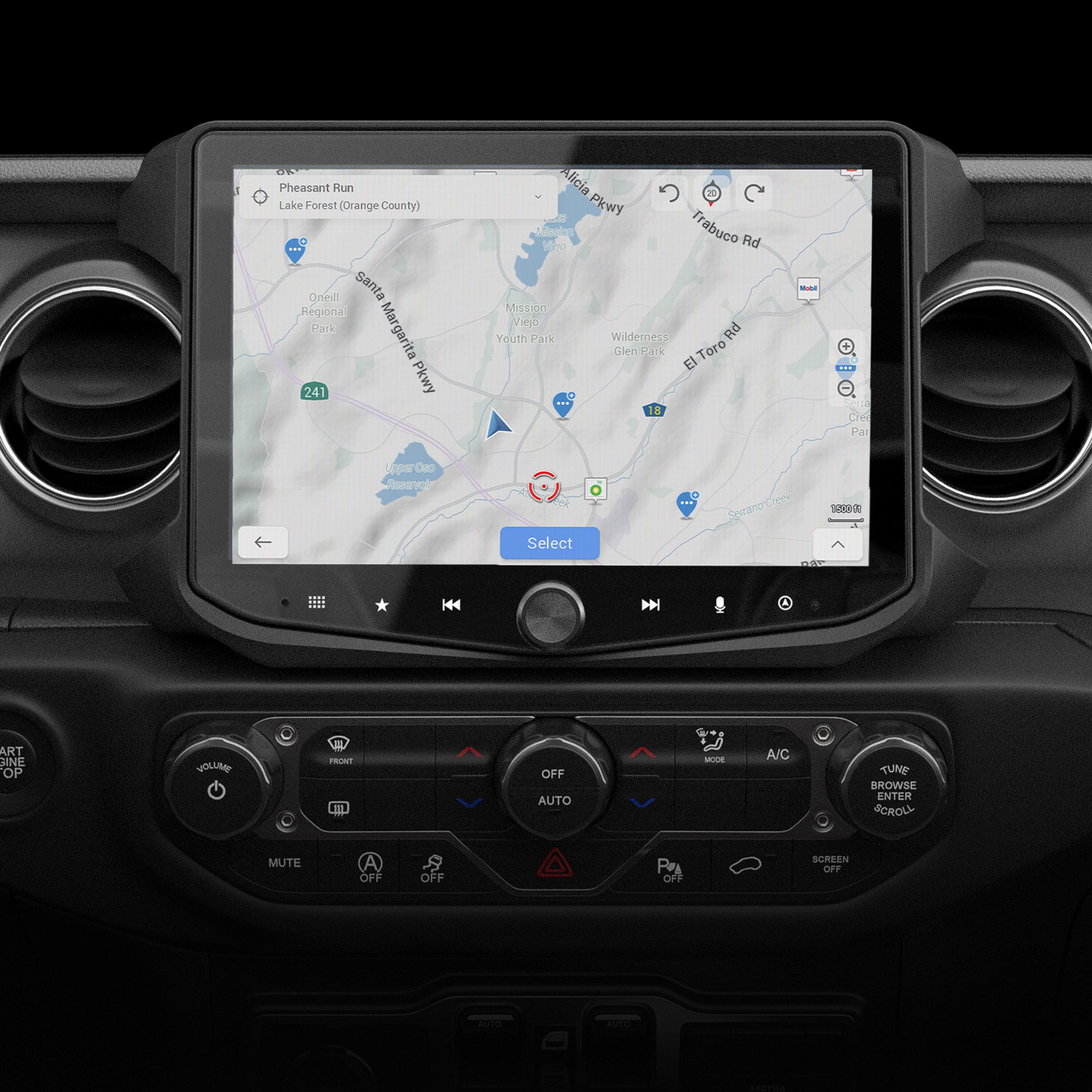 The image shows a car's dashboard with a GPS navigation system displaying a map of Lake Forest, Orange County. The map is showing various streets, including Pheasant Run, Alicia Parkway, and Serrano Creek Road. The GPS system also provides options for selecting different routes, such as selecting a destination or browsing through the map. Additionally, the car's temperature and air conditioning controls are visible on the dashboard.