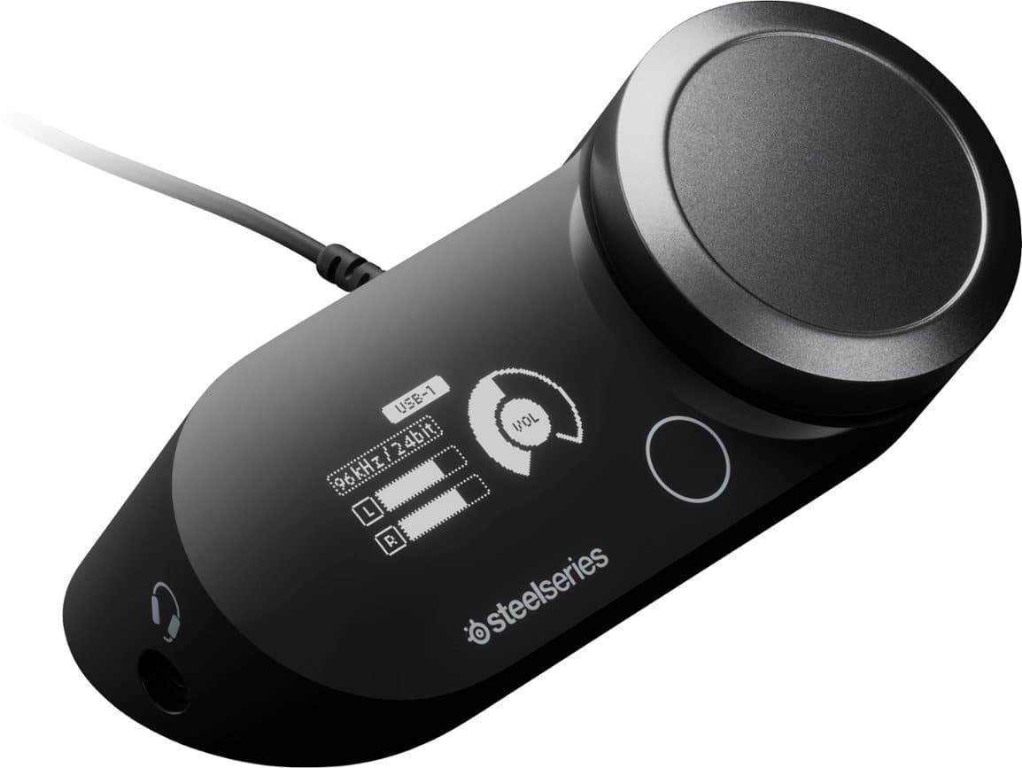 The text on the image reads: "USB-1 VOL 96kHz/24bit EO 24bit L 1 R osteelseries." This text is likely a description of the device, which is a black USB-1 audio device with a volume control. The device is designed for high-quality audio output, with a sampling rate of 96kHz and a bit depth of 24 bits. The "L 1 R" may refer to the left and right channels of the audio output. The "osteelseries" branding suggests that the device is made by the company Osteelseries, which is known for producing gaming peripherals and accessories.