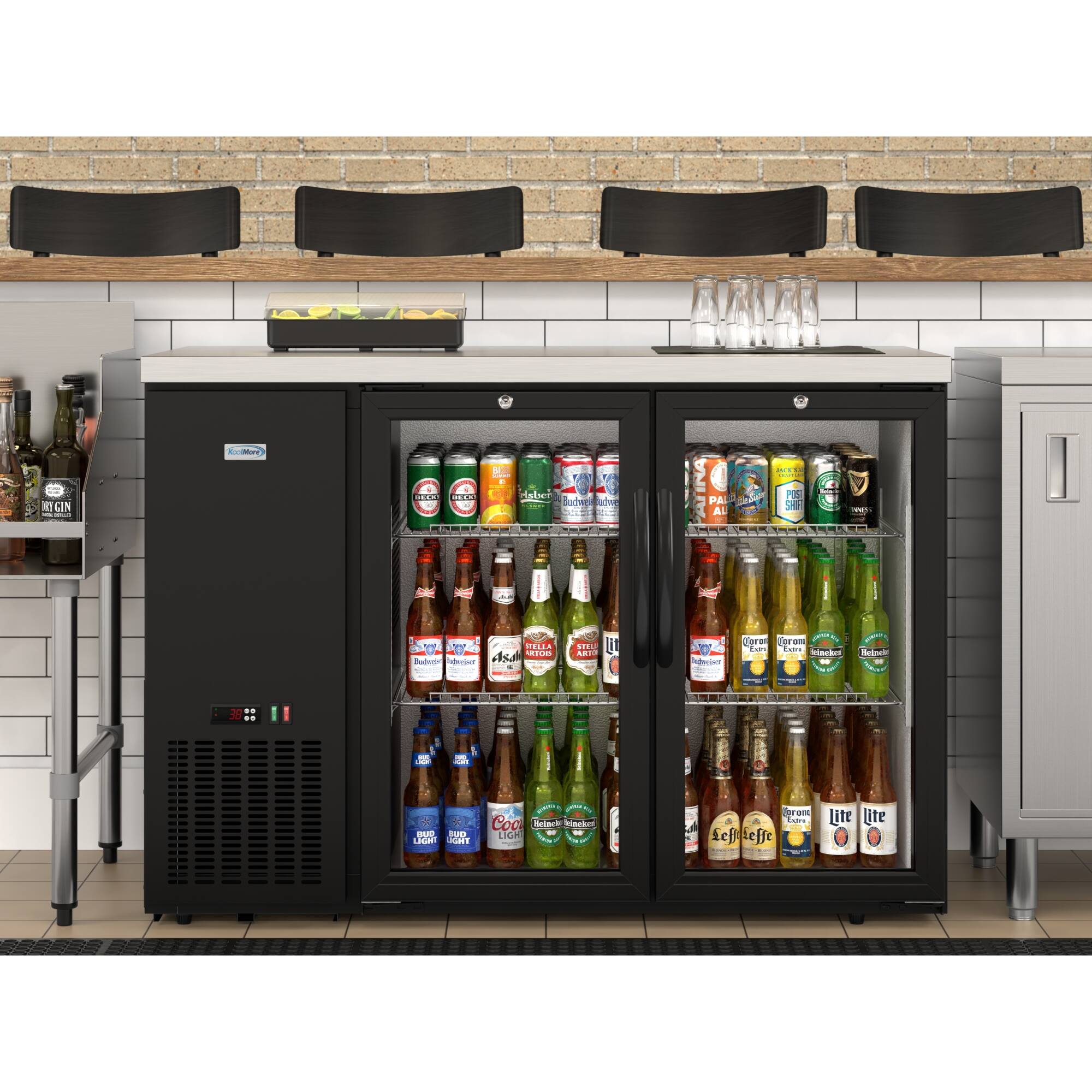 The image features a refrigerator stocked with a variety of beer bottles. The refrigerator is filled with different types of beer, including Budweiser, Corona, and Heineken. There are at least 13 bottles visible in the refrigerator, with some placed in the door compartments and others on the shelves. The refrigerator is located in a room with a brick wall, and there are chairs nearby.