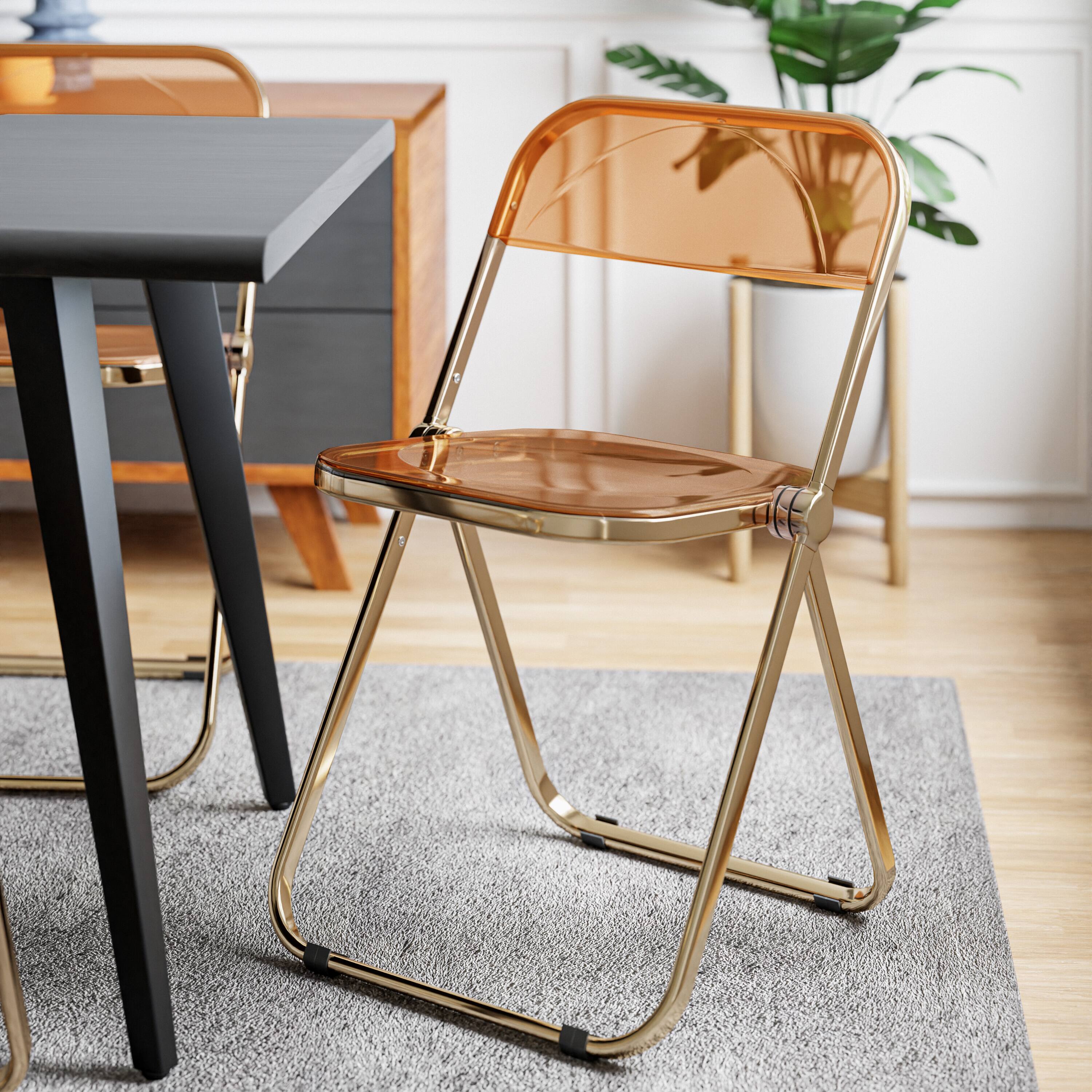 Angle. LeisureMod - Lawrence Clear Acrylic Folding Chair, Modern Gold Chrome Frame, Fully Assembled Portable Dining Seat - Tangerine.