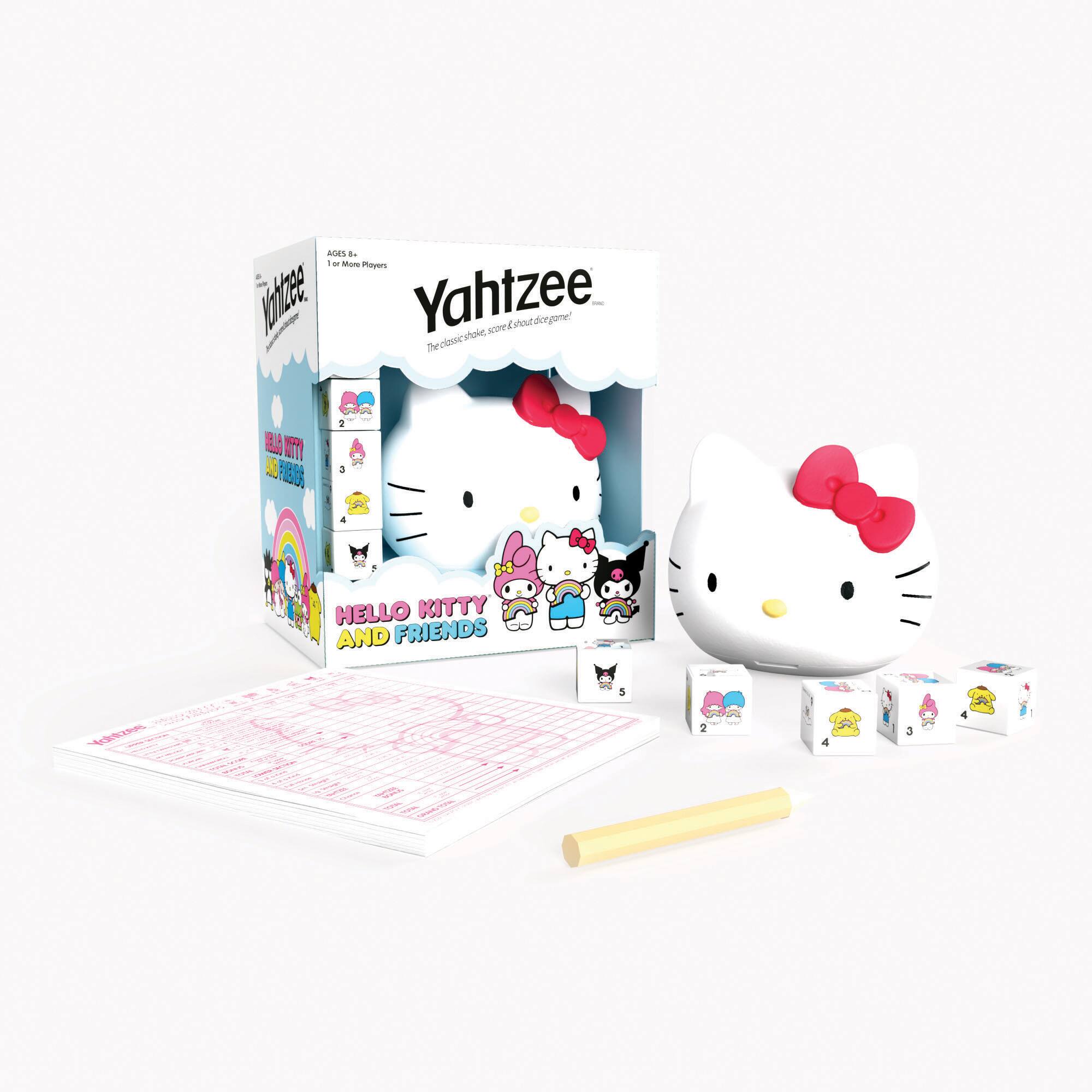 The image features a Hello Kitty and Friends Yahtzee game. The game is displayed in a box, and a Hello Kitty figurine is sitting on top of the box. The game includes a set of dice and a score card, which is placed next to the box. The Hello Kitty figurine is also accompanied by a bow, making it a cute and fun addition to the game.