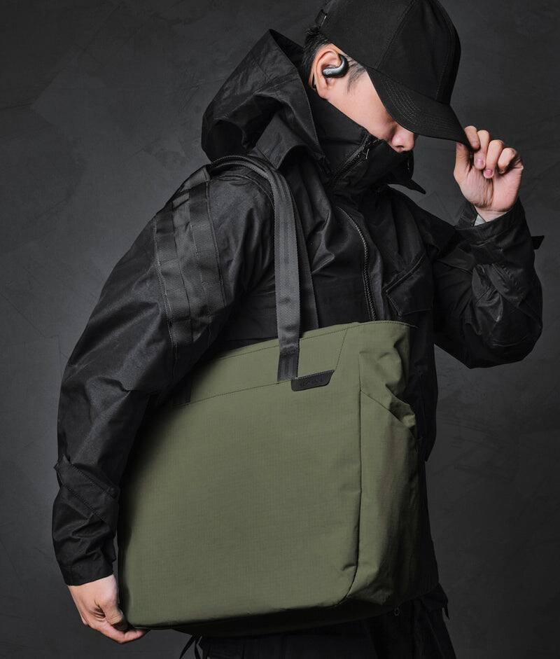Left. ALPAKA - Metro Tote Laptop Tote Bag for Work, Work Tote Fits 16" MacBook Pro, Side Bottle Pocket, Weather-Resistant, Key Tether - Green Axoflux 210D.