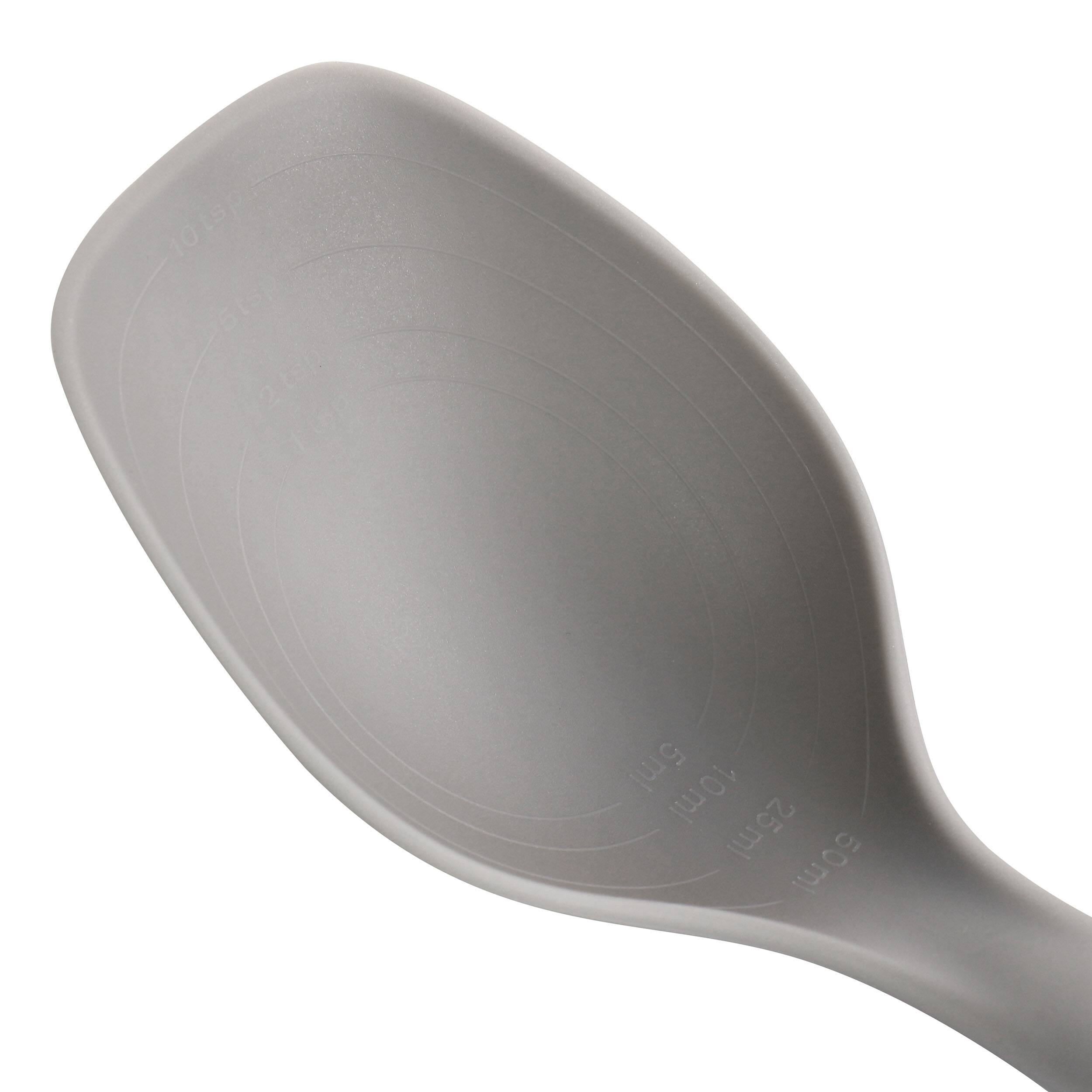 The image shows a spoon with a measuring scale on it, indicating the following measurements: 10 tsp (2 tsp), 110 ml, 10 ml, 25 ml, 50 ml.