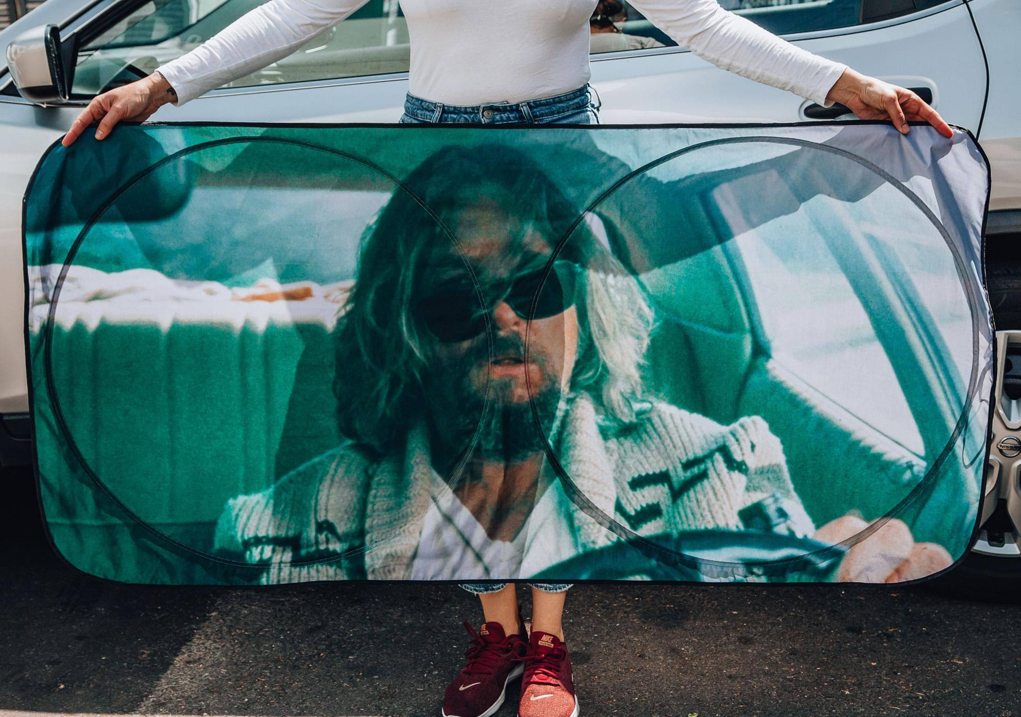 Alt View 2. Surreal Entertainment - The Big Lebowski The Dude Driving Sunshade for Car Windshield | 64 x 32 Inches - Brown.