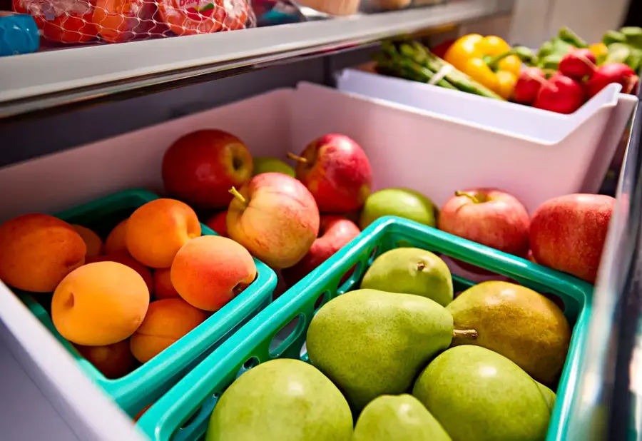 The image shows a refrigerator filled with a variety of fruits, including apples, pears, and oranges. The apples are placed in the top left section of the refrigerator, while the pears are located in the top right area. The oranges are placed in the bottom left section. The refrigerator is well-stocked with a variety of fresh fruits, making it a healthy and convenient option for snacking or meal preparation.