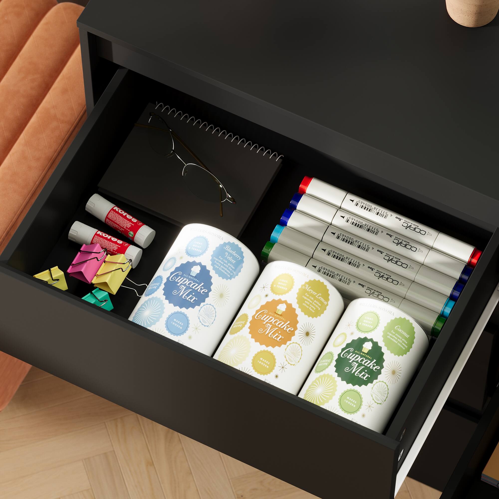 The image shows a black desk with a drawer open, revealing various items such as a notebook, sunglasses, and a cupcake mix. The text on the image is a mix of different phrases and sentences, which do not form coherent sentences or paragraphs. Therefore, it is not possible to group or correct the text based on the given image description.