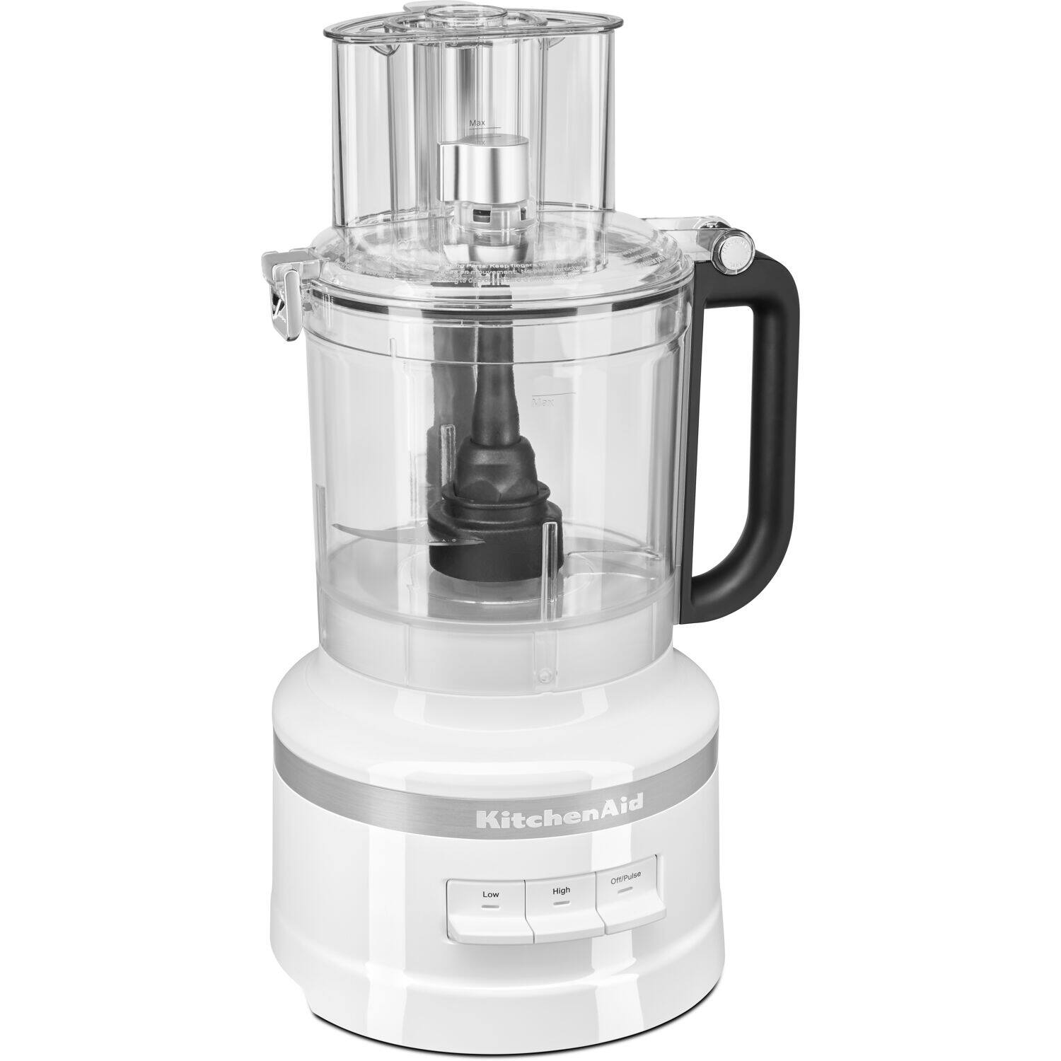 The image features a white KitchenAid blender sitting on a counter. The blender is turned off, and the lid is still attached. The blender is a versatile appliance that can be used for various tasks, such as mixing, pureeing, and blending. It is a popular choice for home cooking and can be found in many kitchens around the world.
