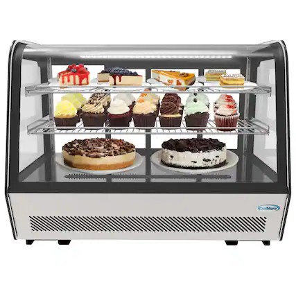 The image features a display case filled with a variety of desserts, including cakes and cupcakes. There are at least 12 different cakes and cupcakes in the case, each with unique flavors and designs. The display case is illuminated, making the desserts look even more tempting and appealing. The case is likely found in a bakery or a dessert shop, where customers can choose from the wide selection of delicious treats.